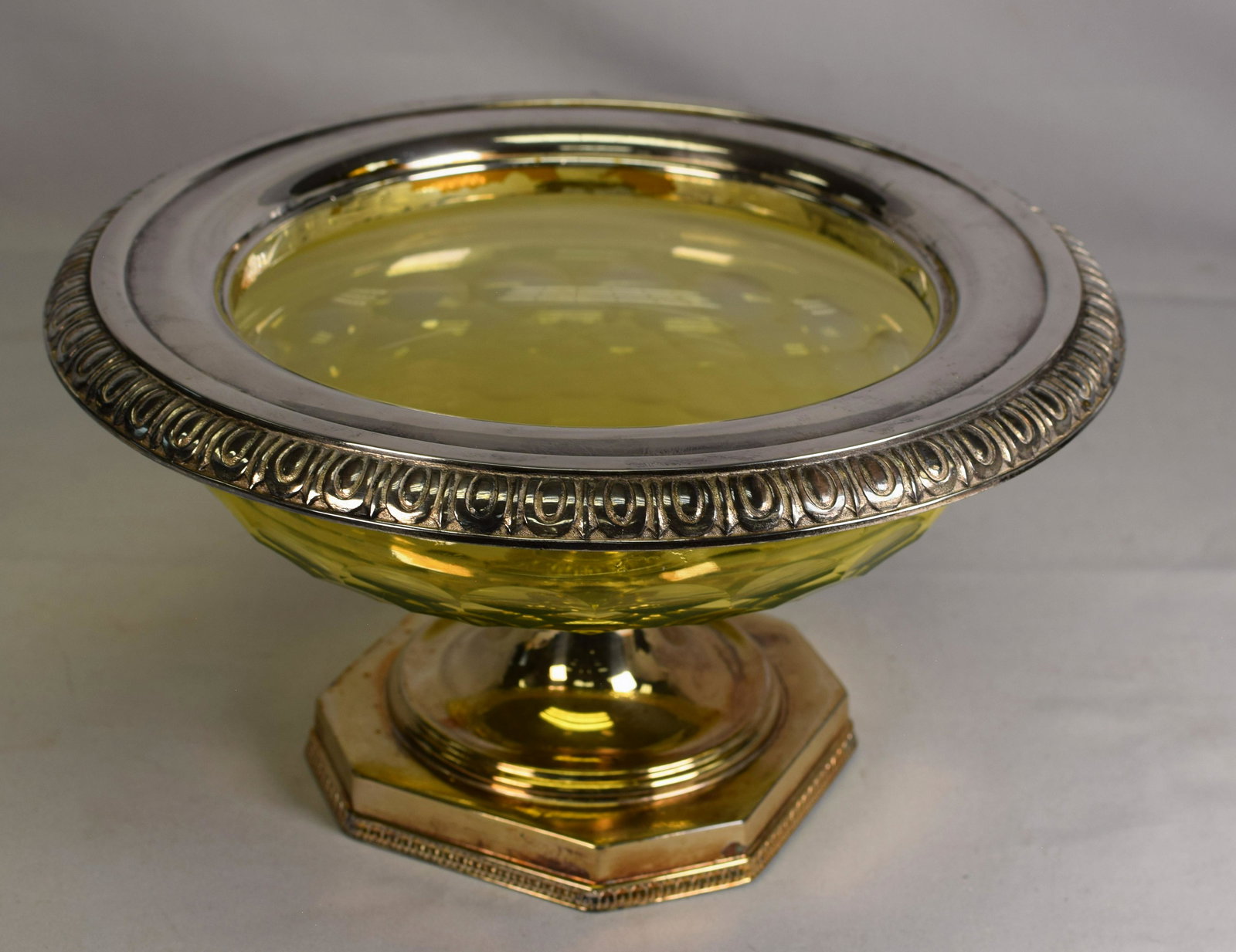 PAIRPOINT GLASS CANARY & SILVER-PLATED FOOTED BOWL: Wonderful Pairpoint cut canary glass center bowl with silver-plate rim, base and foot. Canary glass cut faceted. Base signed with Pairpoint with P and numbered C5536. 6 1/2 inches tall x 12 inchesacro