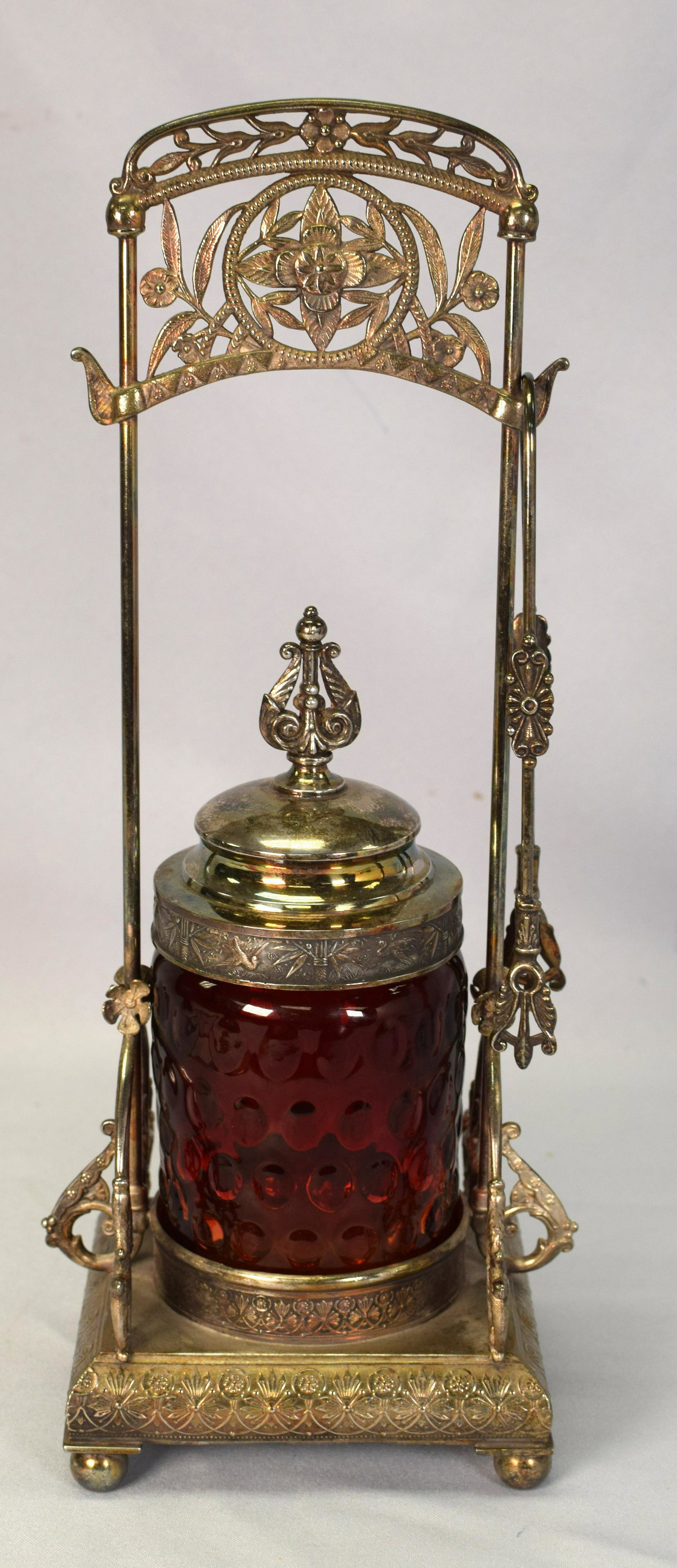 RARE VICTORIAN PAIRPOINT PICKLE CASTOR: Rare Victorian silver plate pickle castor by Pairpoint decorated with a filigree design on base and floral design on frame. Beautiful amberina hobnail jar with silver plate lid adorned with afinial an