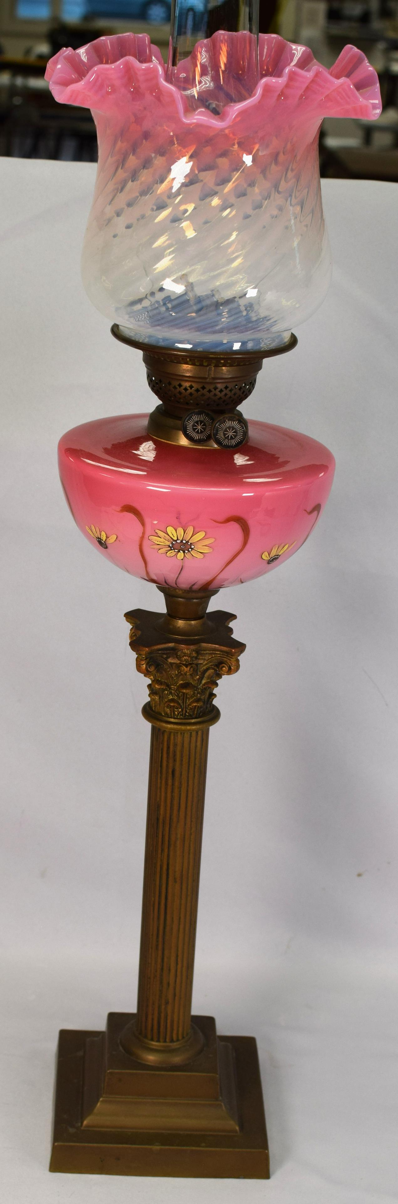 VICTORIAN BANQUET LAMP: Beautiful Victorian banquet lamp with brass Corinthian column pedestal base supporting a deep rose glass font adorned with hand-painted daisies and a pale pink opalescent swirled shade. Circa1860's - 
