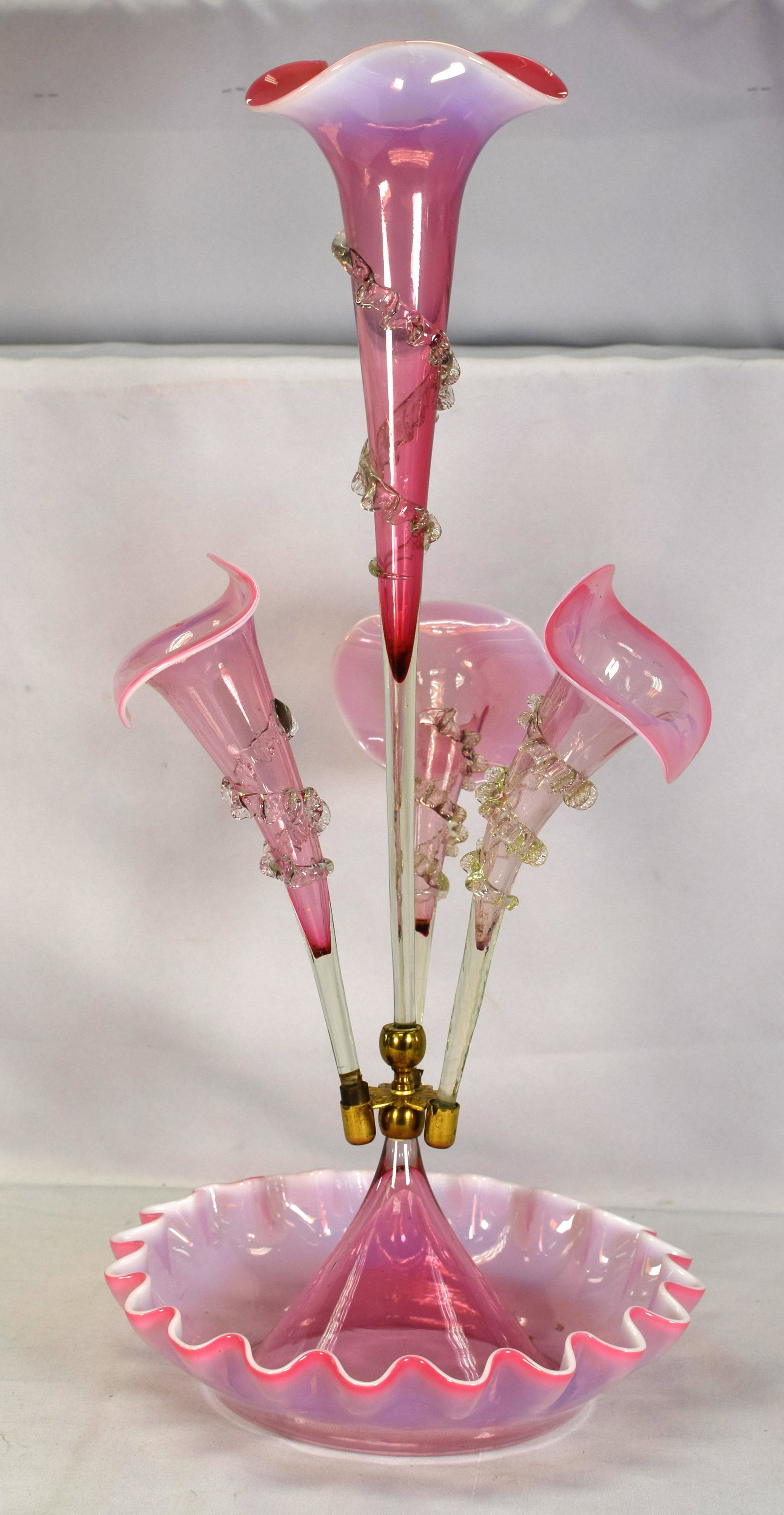 VICTORIAN PINK GLASS EPERGNE, 19TH C: Victorian Pink Glass Epergne, 19th Century, with ruffled rims, a tall trumpet-shaped vase centering three smaller vases, each with applied clear spirals and alternating with clear twisted canes,overal