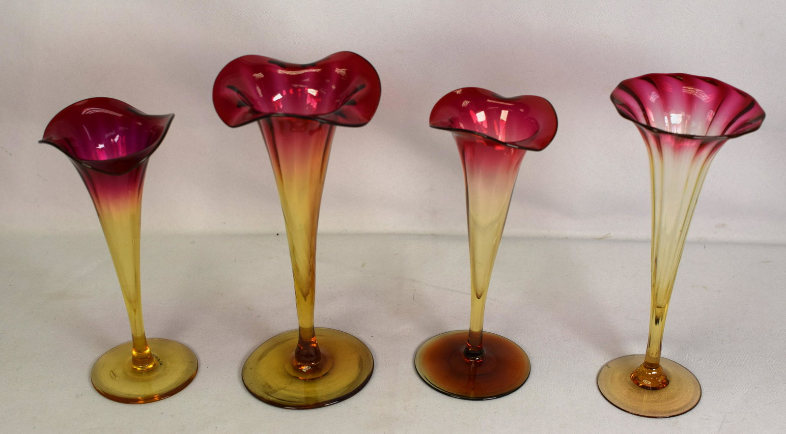 (on-4) NEW ENGLAND AMBERINA LILY TRUMPET VASES: Four wonderful period 1880's amberina lily trumpet glass vases. Largest 7 3/4 inches to 6 1/2 inches. All free of chips and cracks. One with imperfection in making. Good condition.