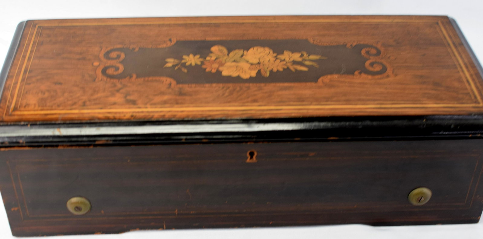1878 SWISS 6 TUNE CYLINDER MUSIC BOX: Nice table top 6 tune Swiss music box. Original dated label 1878. Inlaided painted mahogany case. 20 inches wide x 8 1/2 inches deep x 6 inches tall. Working condition. No broken teeth. Has key. Good 