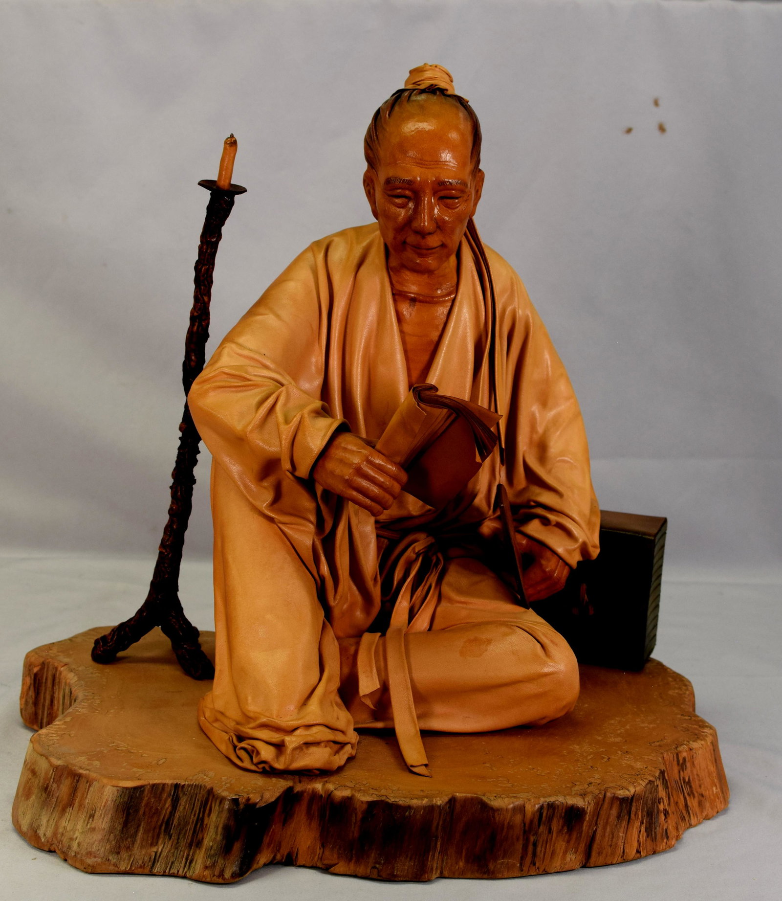 LIU MIAO CHAN CHINESE LEATHER SCULPTURE: Large detailed leather sculpture by Taiwanese artist Liu Miao Chan (born 1946). Depicts a man reading by candlelight. Title Reading in Cold and Late Night. Figure measures 14 inches tall, seated on a 