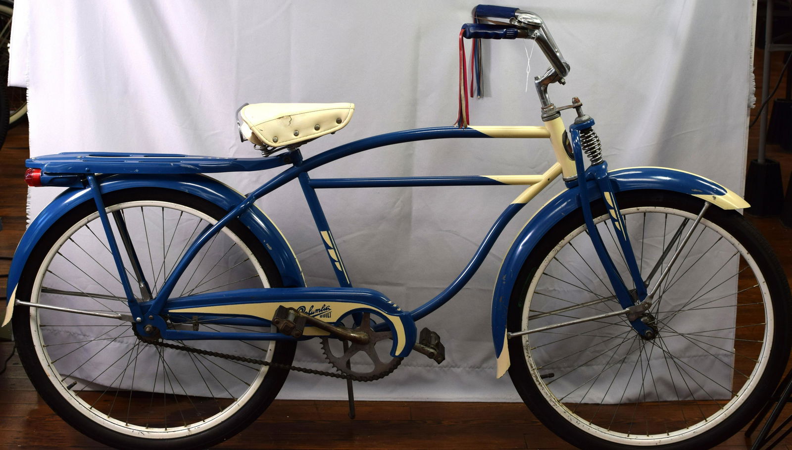 1947 BOYS COLUMBIA SPRINGER FRONT END BIKE: Beautiful 1947 Columbia Boys bicycle with Springer front end, Complete with head badge, rack, white wall tires, streamers. Old repaint. 27 in. Great vintage bicycle.