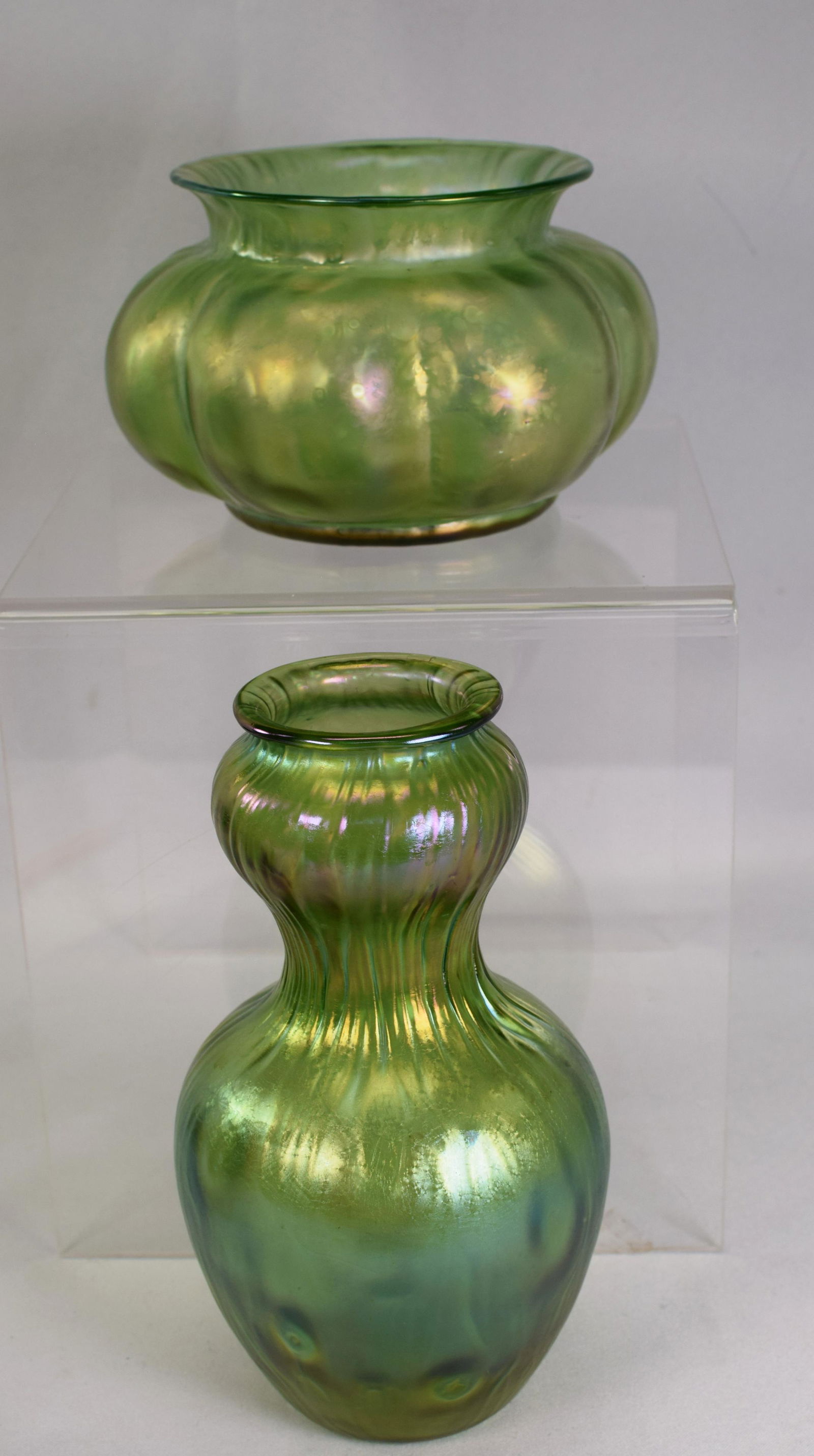 (on-2) LOETZ RUSTICANA GREEN IRIDESCENSE VASES: Ca Late 19th century. Two glass art glass vases. The surface displays rainbow iridescence. Both in Excellent condition. Polished ground pontils. 1) Gourd shade, 8 inches tall. 2) Melon shape withfolde