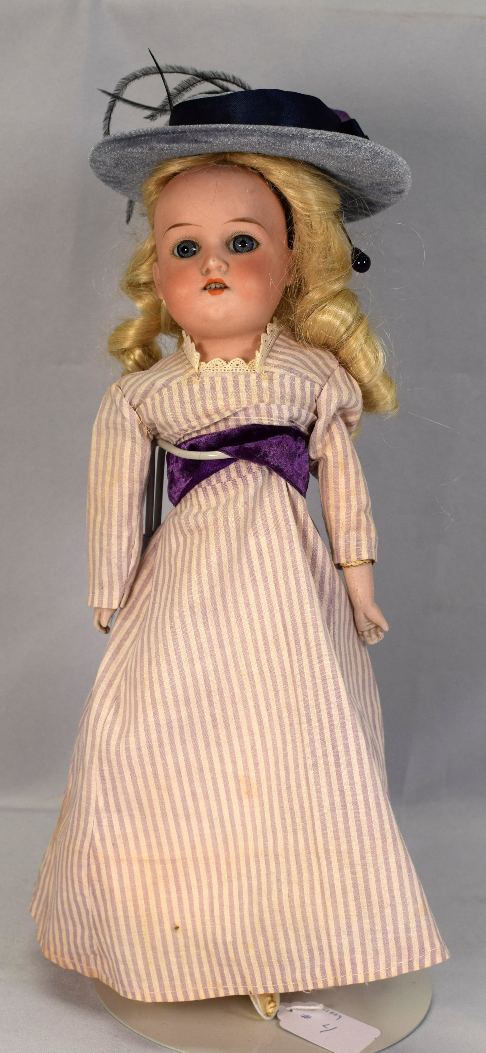 ARMAND MARSEILLE BISQUE HEAD DOLL: Antique Armand Marseille German doll with hand painted bisque porcelain head featuring blonde hair,blue glass stationary eyes,open mouth with 4 porcelain teeth,bisque hands,leather feet andfabric body