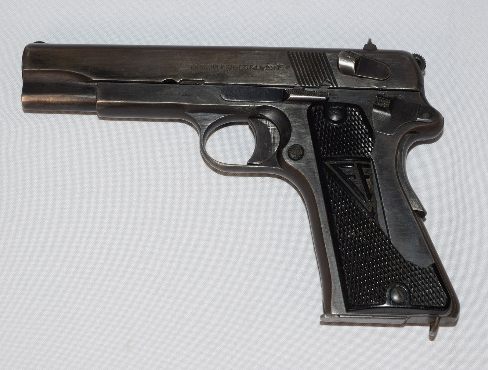 WW2 GERMAN P-35 POLISH RADOM PISTOL: Serial number 15567. Produced in Poland at Radom under German occupation. Polish Radom P-35 pistol with triple latches and slotted butt for shoulder stock. All matching numbers including, frame,slide 