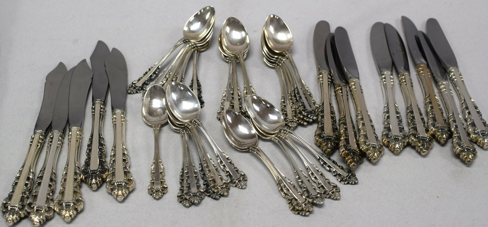 GORHAM MEDICI STERLING DEMITASSE & BUTTER KNIVES: Gorham Medici pattern, 27 demitasse spoons, 4 1/4 inches long approx. 14 weighable troy ounces and 5 cheese knives, 6 3/4 inches long and 8 butter knives Little or no use. Weighs approx. 2lbs.
