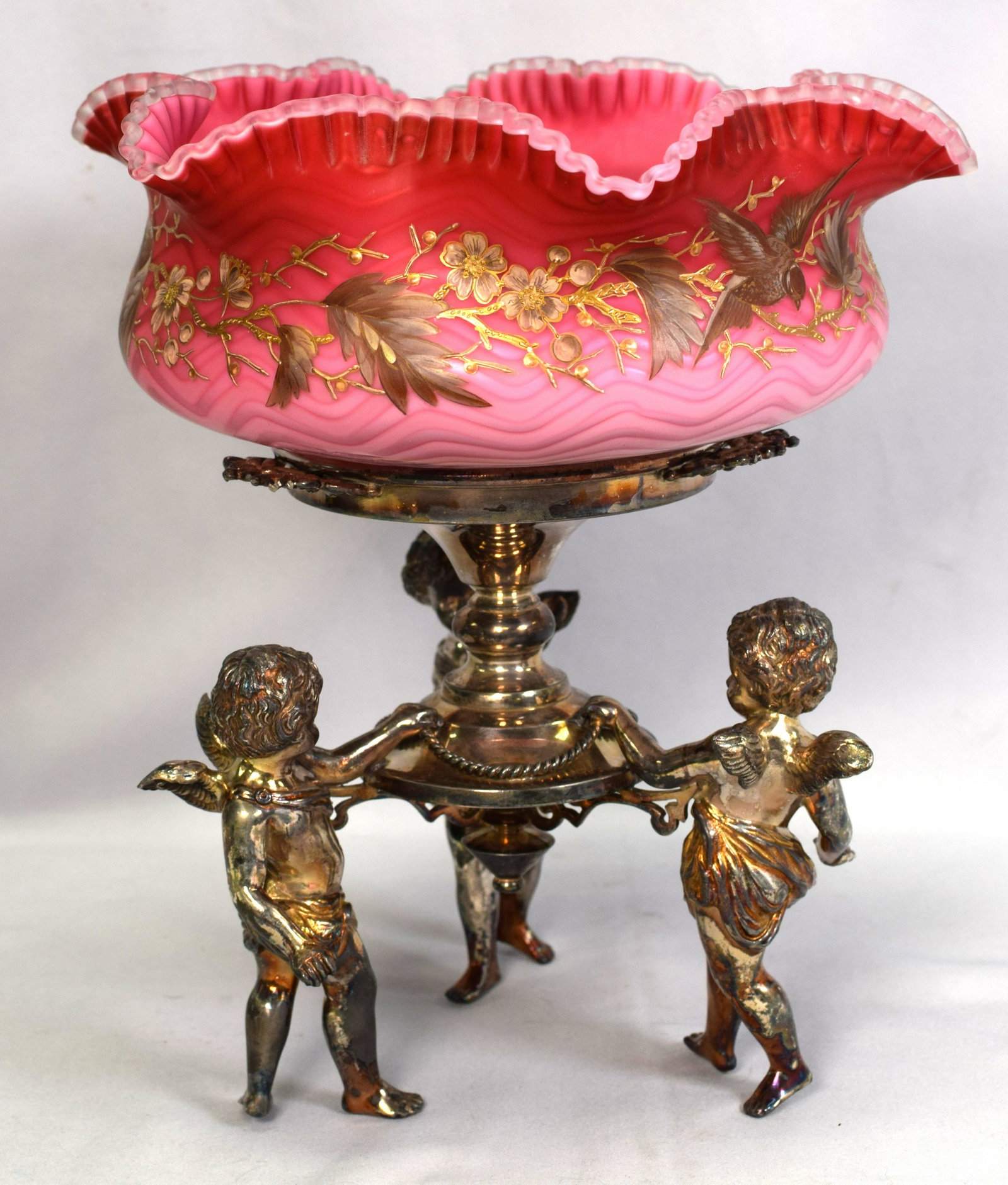 VICTORIAN BRIDES BASKET SILVERPLATE HOLDER: Ca 19th century. Rare pulled Nailsea enamel painted decoration glass brides bowl. Polished pontil. Figural girl on swing. Total of 11 inches tall x 11 in diameter. Holder marked Middletown.Good condit