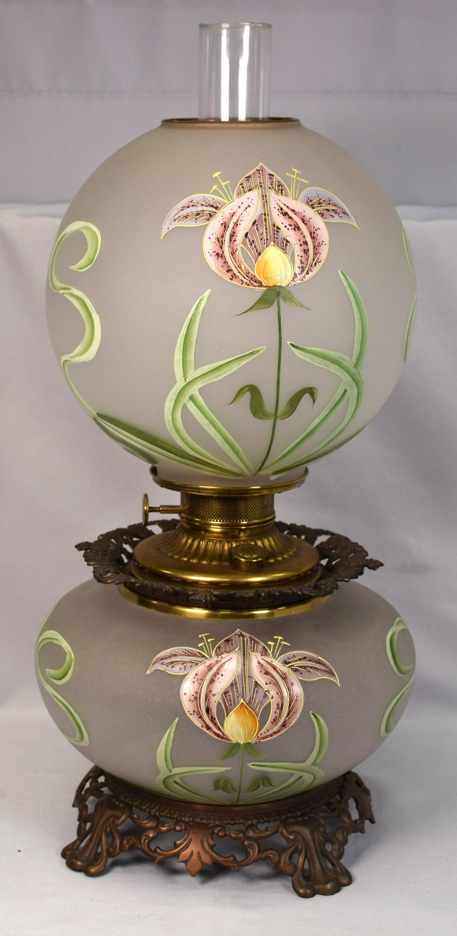 19TH VICTORIAN GONE WITH THE WIND OIL LAMP: Best of the best Victorian gone with the wind 19th oil lamp. Hand painted with enamel lady slippers floral decoration. 11 inches x 11 inches x 23 1/2 inches tall to chimmey top. Frosted glass withlady