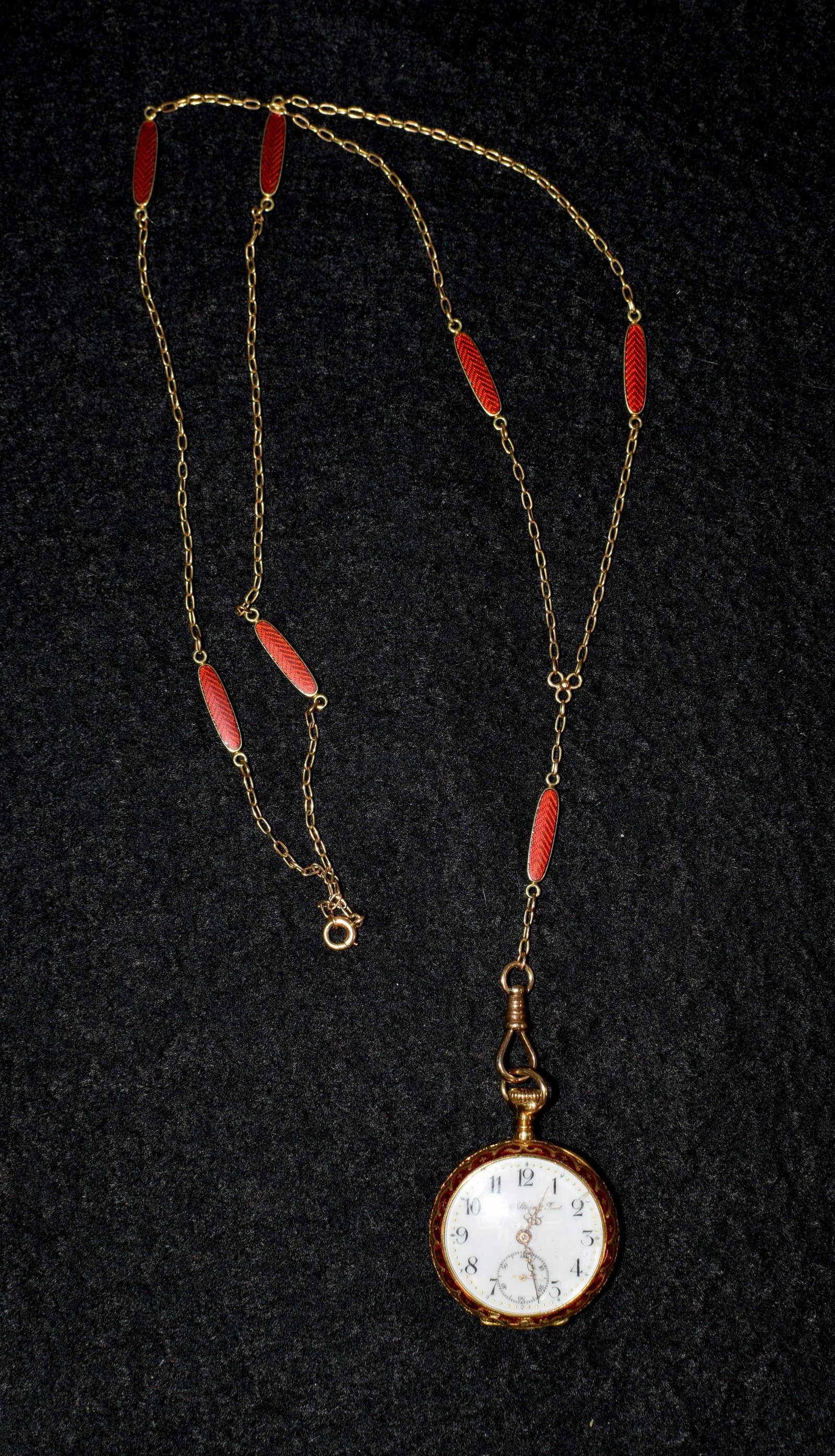 SWISS 18K, ENAMEL AND ROSE CUT WATCH & 14K CHAIN: Lady's 18k enamel and rose cut diamond antique watch. Retail Black, Starr and Frost. 1 1/8 diameter. Swiss works. Watch starts and then stops after about 8 seconds. Red guilloche enamel backwith 10 sm