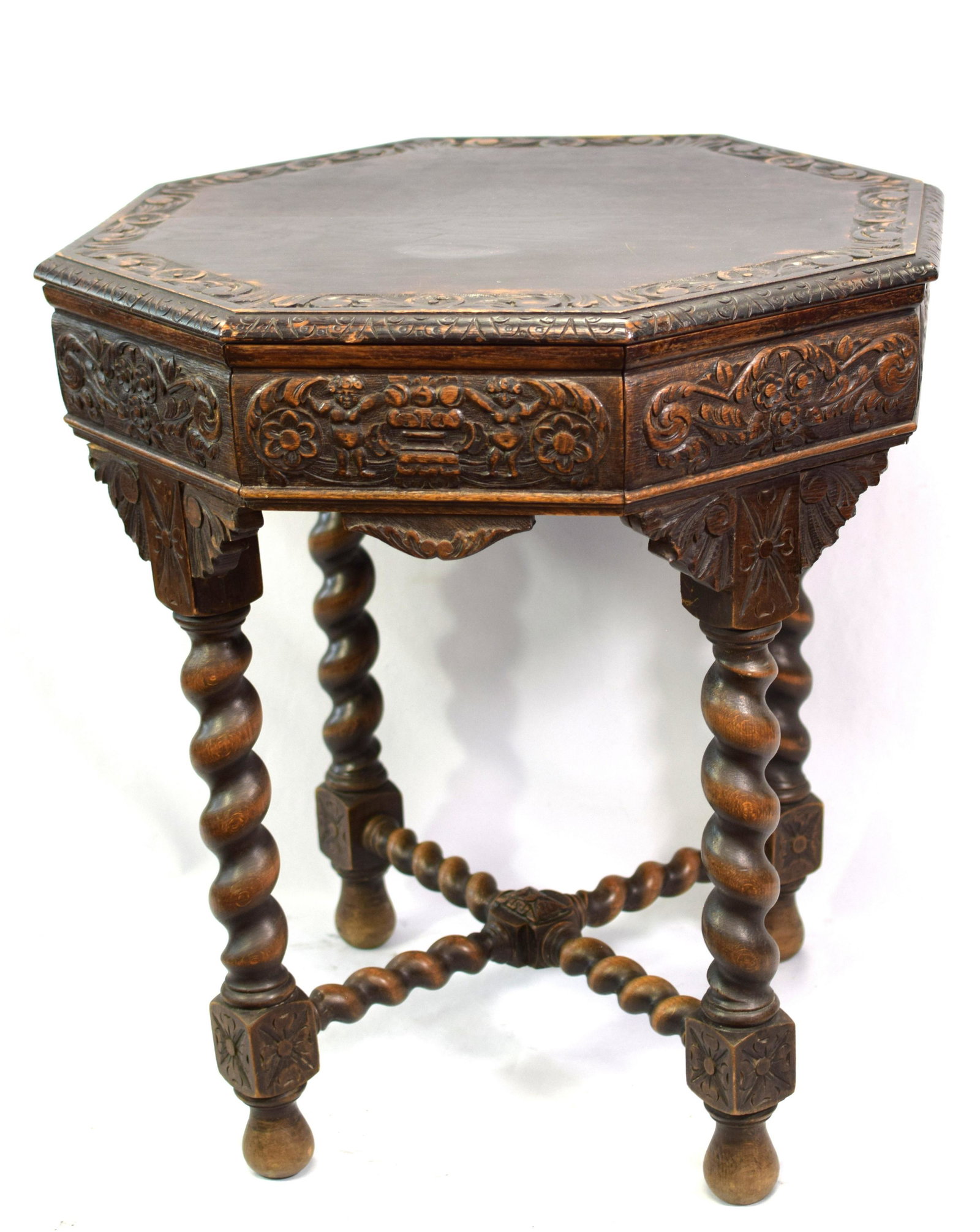 19TH OCTAGON BARLEY TWIST OAK TABLE: French 19th century hand carved oak octagon table with barley twist legs. Ornately carved. Turned and carved cross stretcher. 30 inches tall x 27 edge to edge. Good condition.