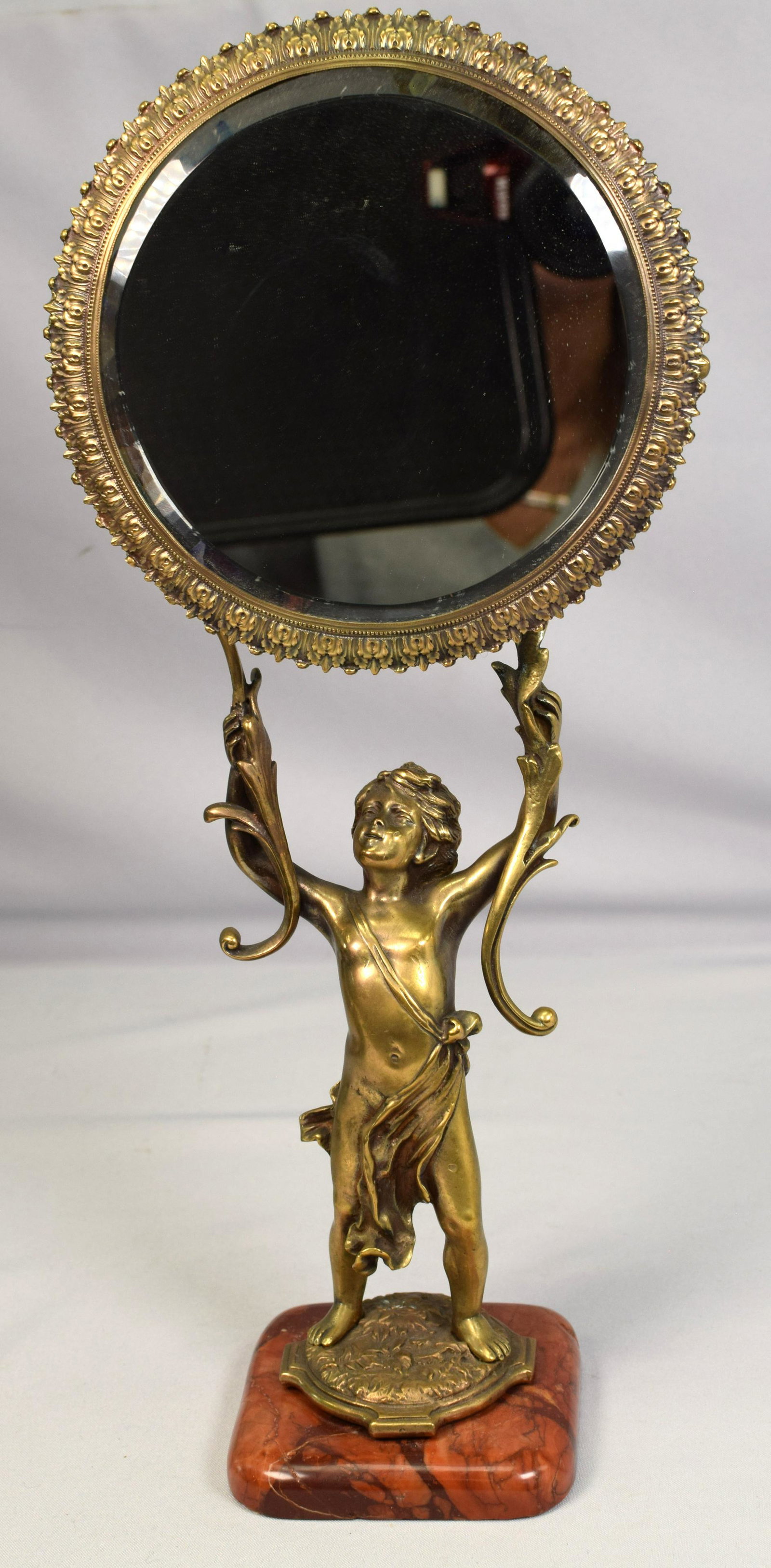 VICTORIAN BRONZE & MARBLE FIGURAL VANITY MIRROR: Old Victorian or Victorian style vanity mirror with bronze putti holding swing bevel mirror. 16 1/2 inches tall x 7 1/2 x 4 inches deep. Good condition. Not signed. Shipping 4 pounds.