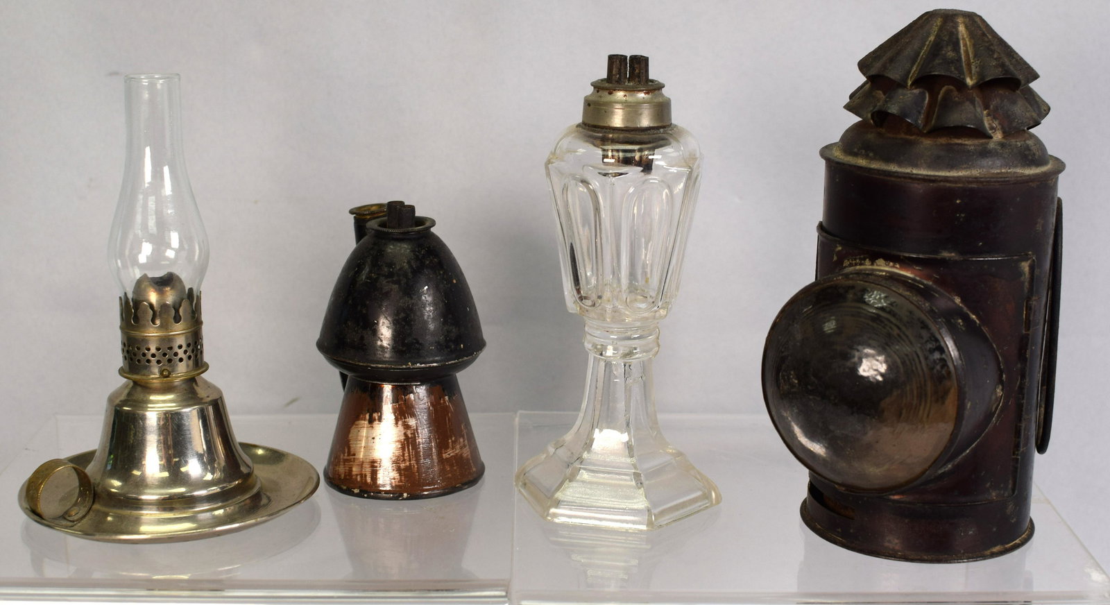 LOT OF EARLY LIGHTING ITEMS: Set includes; 1.) Police lantern 2.) Whale oil lamp 3.) Fluid lamp4.) Lemon top made of tolware, black and has japanning Overall good condition 8in x 6in x 7 1/2in, 2lbs.