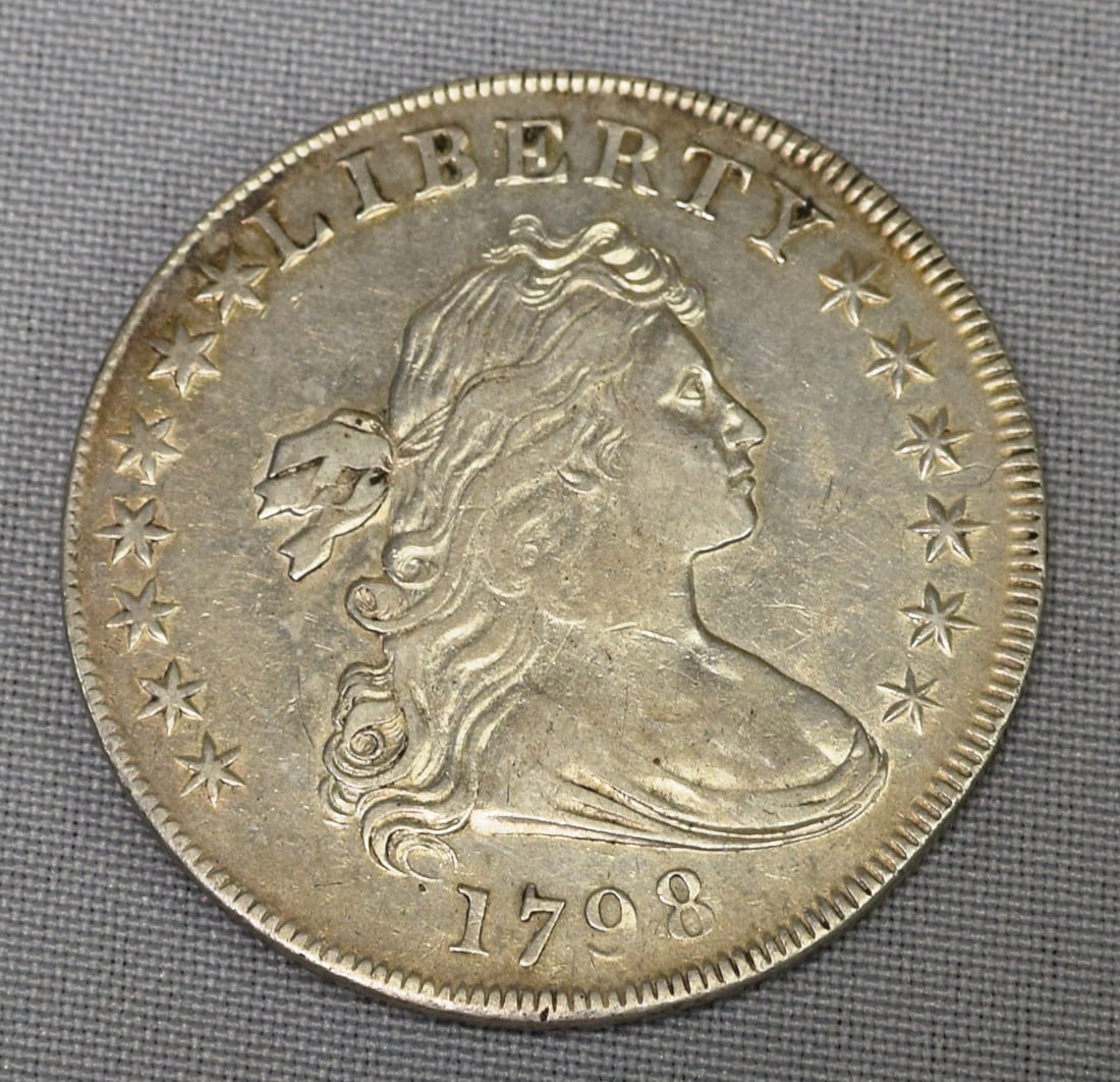 1798 US SILVER DOLLAR: 1798 silver dollar. Some scratches on back side. Visible in photos. Whites auctions does not grade coins. Large eagle bust. Circulated.