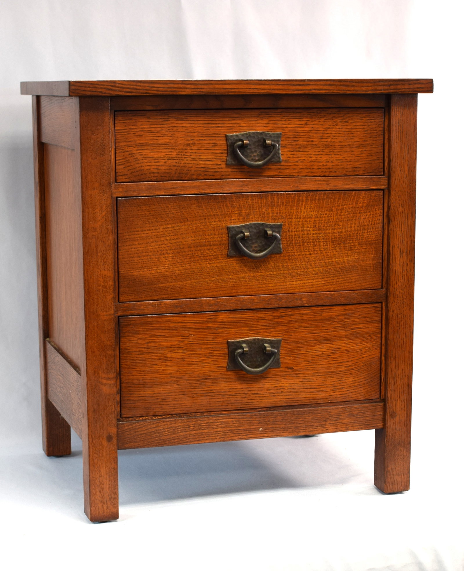STICKLEY ARTS & CRAFTS 3 DRAWER OAK NIGHT STAND: Three drawer Arts & Crafts mission oak night stand. Highest quality handcrafted craftsman in the Stickley style. Maker's brass place inside drawer "Antiquities Stickley". 25 1/2 inchestall x 21 1/2 in