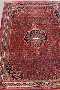 BIDJAR PERSIAN ORIENTAL ROOMSIZE RUG: Red field with overall pattern medallion center. Dark blue border with alternating turtle design. Multiple small borders. 8 feet 6 inches x 12 feet 2 inches. Circa 1930's. Gregorian Rugs old label.