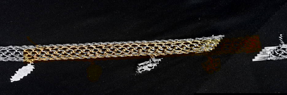 14K YELLOW GOLD BRACELET WITH 2 CHARMS: Vintage 14k bracelet. 7 1/2 inches long x 9/16 inch wide. Two 14k charms. Good condition. Approx. 21.8 dwt. Whites Auctions does not grade coins. Whites will not accept credit cards on gold, coins and
