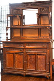 19TH AMERICAN OAK VICTORIAN MIRROR BACK SIDEBOARD: Two pieces. Four drawers over two doors with multiple shelves with center bevel mirror. Fancy carving. Ca 1870's. Some missing moldings. Visible in photos. 80 inches tall x 54 inches wide x 22inches d