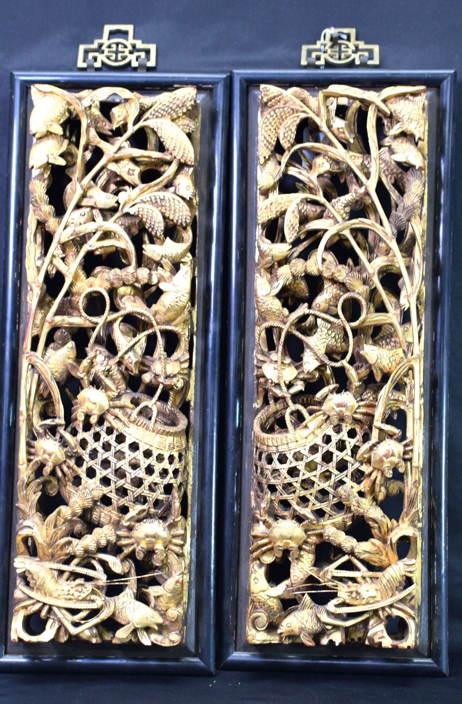 PAIR CHINESE GILT CARVED PANELS: Detailed carving with roped fishing net/basket, fish, crabs, lobster and seaweed. Measures 16 i/4 inches x 5 inches (excluding frame). Overall 18 inches x 6 3/4 inches. One has break in the ropeotherw