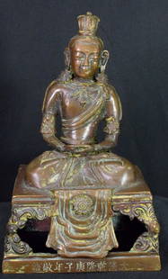 TIBETAN BRONZE BUDDHA AMITAYUS: Ging Dynasty. Seated on faux 'textile' covered open throne, bronze Sino Tibetan figure of Buddha Amitayus. Inscriptions on the bottom front. Measures 7 inches tall. Base 4 1/4 inches x 3 1/4inches. Go