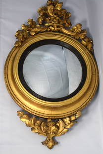 19TH C GILDWOOD & GESSO CONVEX MIRROR: Original 19th century gilt wood and gesso framed convex mirror. Original convex glass mirror. Carved gilt wood wood and gesso oak leaf cluster crest and finial Measures overall 40 inches x 23inches. M