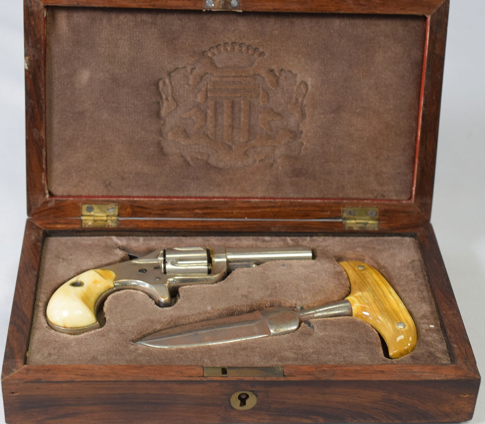 BOXED CASED 22 CAL. NEW LINE COLT AND PUSH DAGGER: Wonderful 1875 Colt 22 cal. New Line pistol or revolver with bone grips. Signed Colts PT FA Mfg. Co. serial # 38244. Push dagger with polished horn grip. Marked SHEFFIELD and I-XL. Velvetfitted inlaid