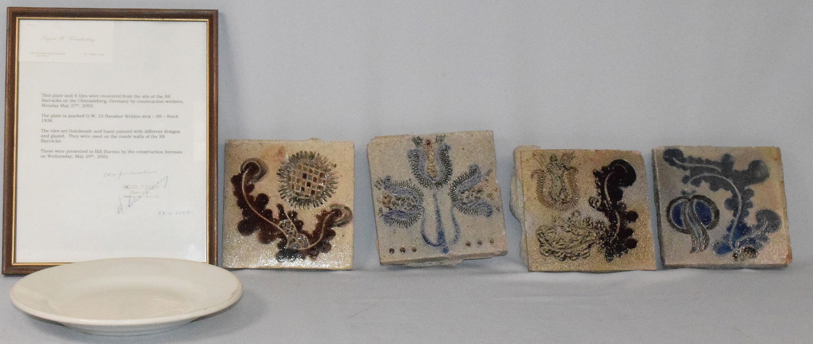WWII GERMAN SS BARRACKS WALL TILES AND PLATE: Estate collection of William Bureau of WWII Third Reich Military. Four wall tiles and 1 plate with COA from SS barracks in Obersalzberg Germany. COA 2002 The plate is marked on bottom with "Bausher We