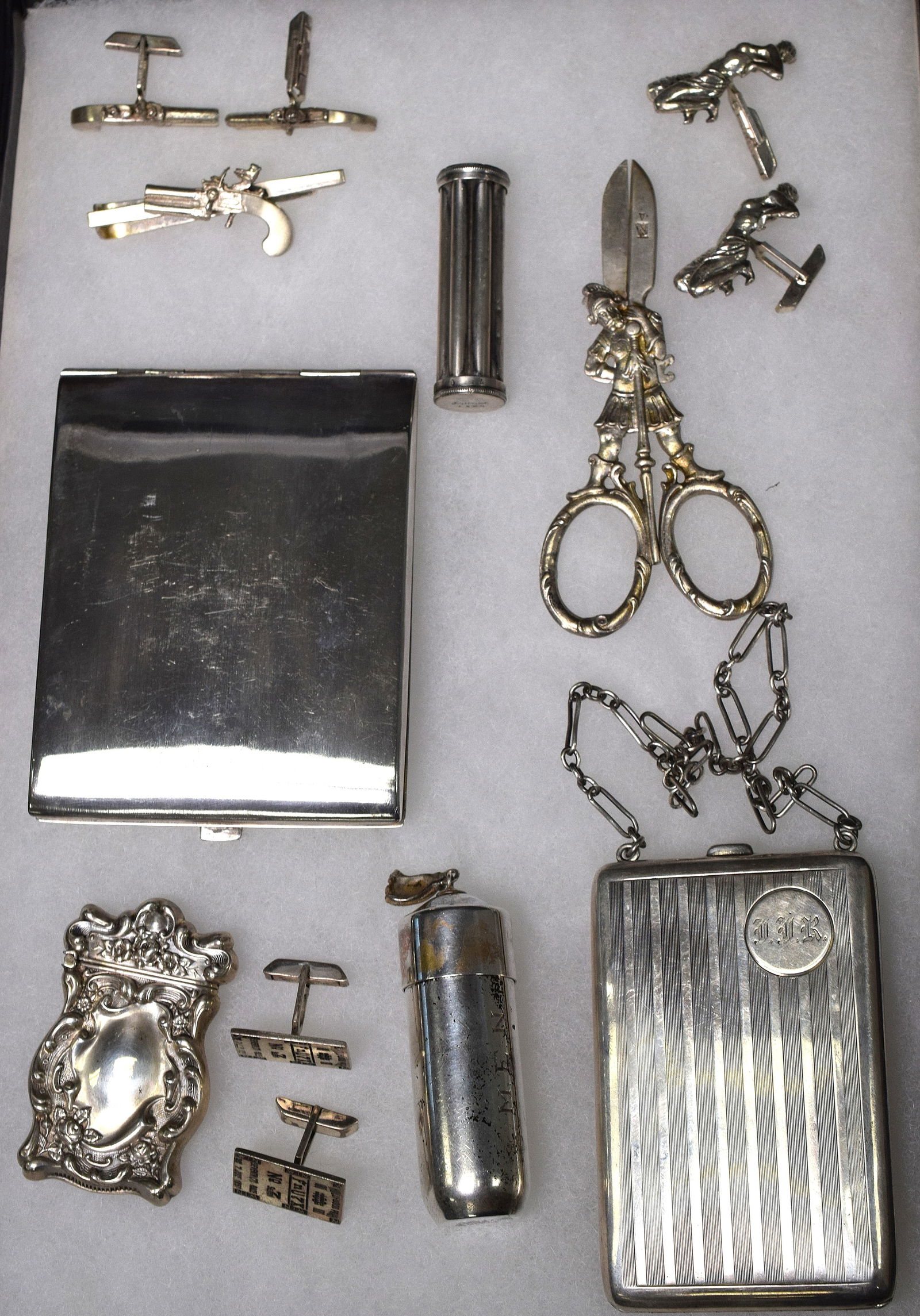 9 ASSEMBLED SILVER PIECES, JEWELRY & ETC: Consists of 1) Sterling silver match safe case with repousse ornate design. Good condition. 2 1/2 inches tall. 18 grams. 2) Tiffany & Co. sterling cylinder form sewing kit with tassel finial.containin