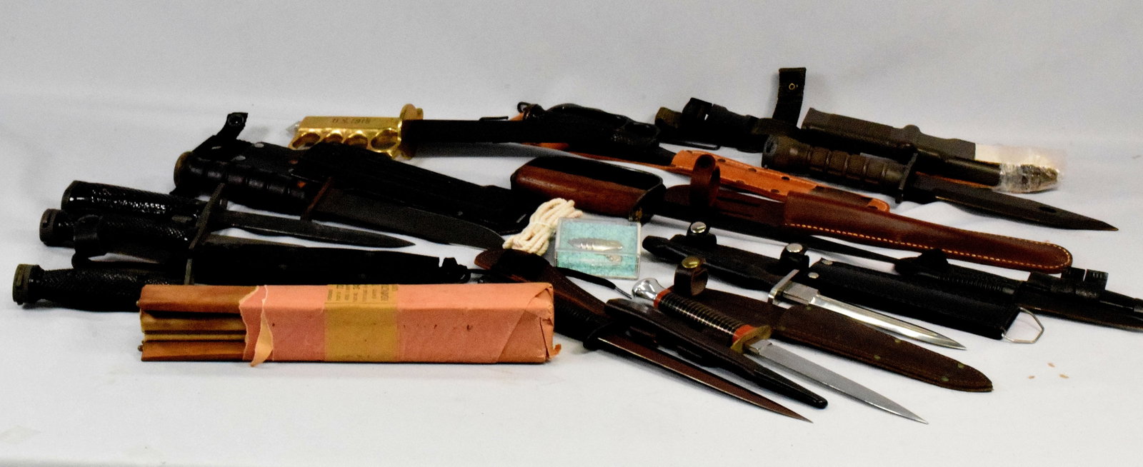 VARIOUS FIGHTING KNIVES: 1) Marked US M3, SEMS, 1943. Has leather sheath. Black handle. 14 1/2 inches long. 2) Brass handle reproduction fighting knife. Metal sheath. 12 inches long. 3) Wooden handle US L.F. & C. 1917reproduc