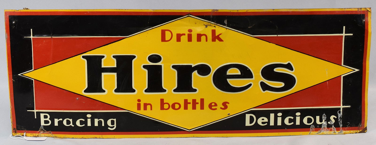 HIRES ROOTBEER TIN ADVERTISING SIGN: Original Hires Root Beer tin advertisement sign circa 1920's. Sign has yellow diamond in the center set inside a red rectangle set to a black field and reads Drink - Hires in bottles - Bracing Delicio