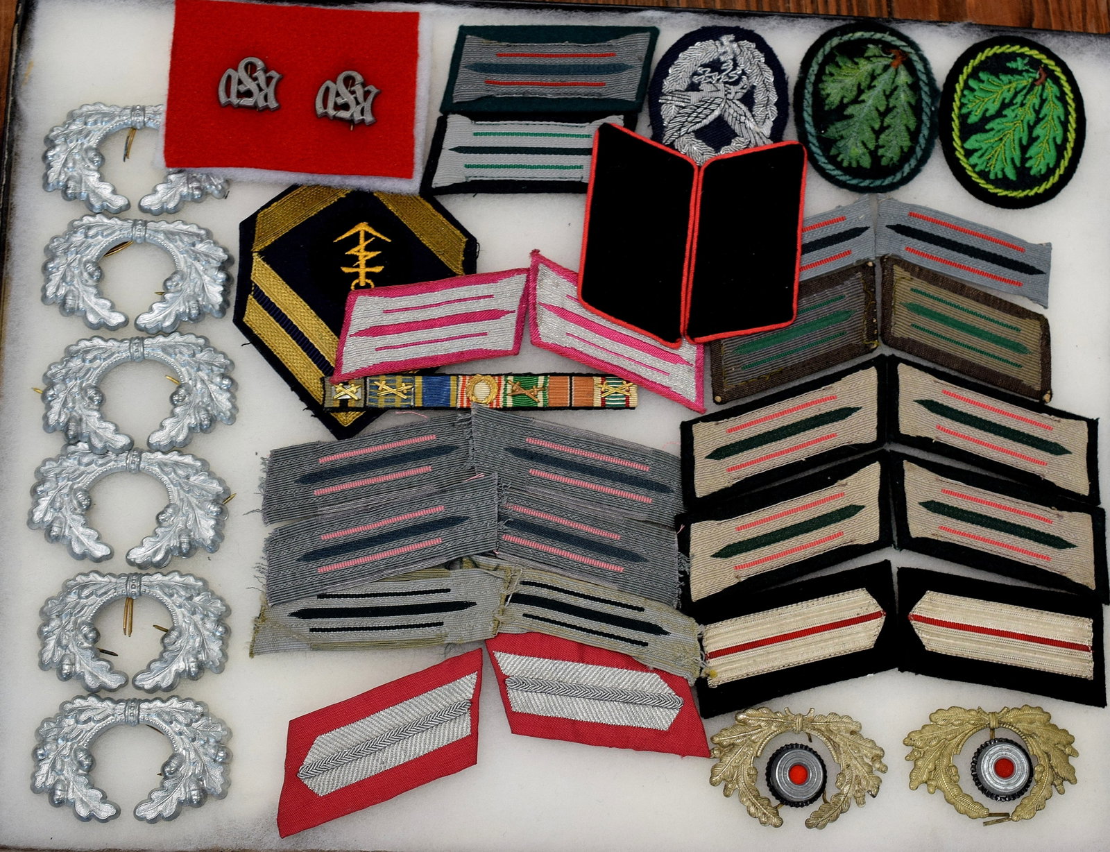 RIKER CASE WWII GERMAN PATCHES & ETC.: Consists of 26 pieces. Estate collection of William Bureau of WWII Third Reich Militaria. Consists of Stripes, hat pieces, and patches. Collection are antique, new, vintage andreproductions pieces. So