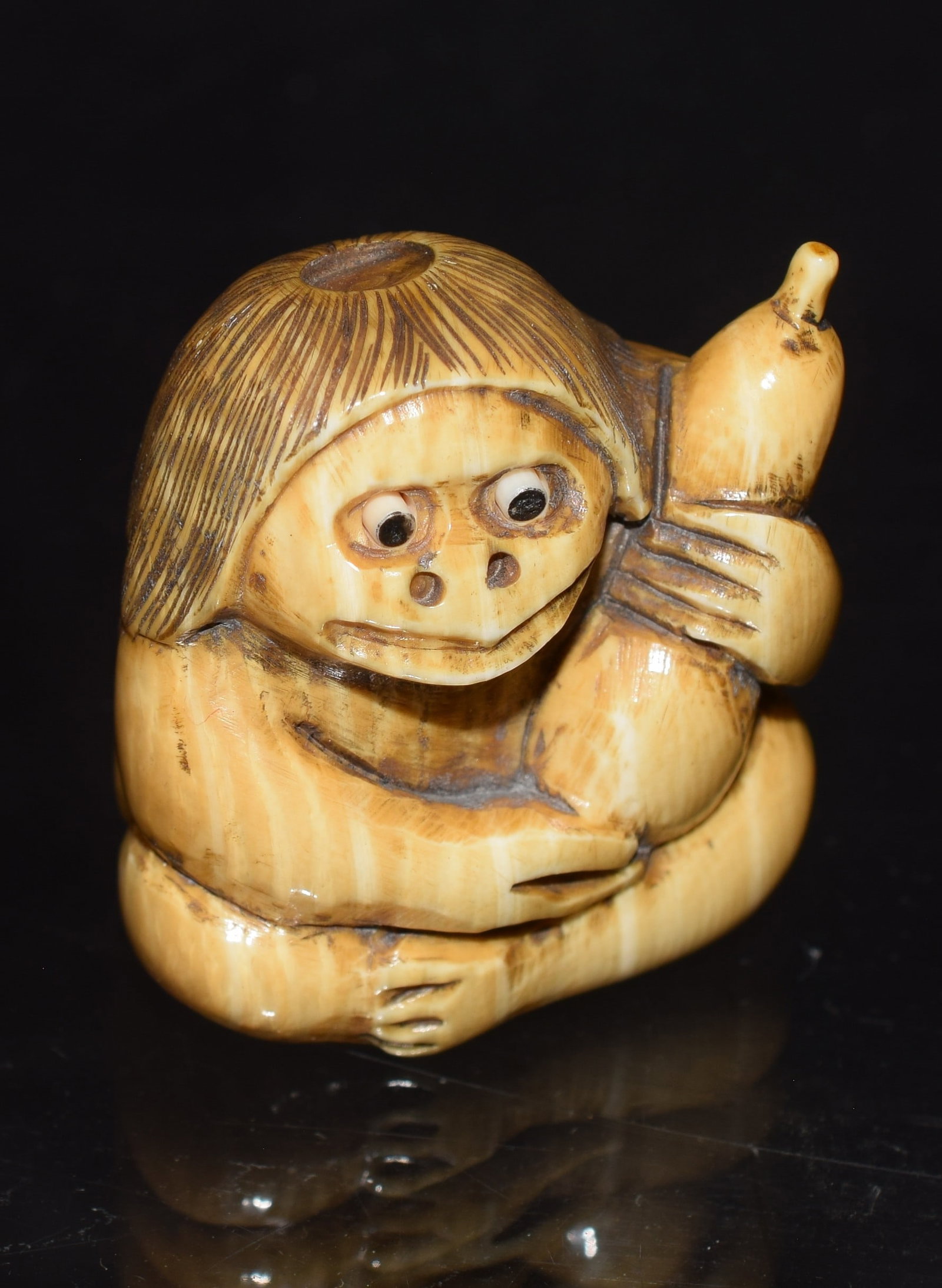 JAPANESE NETSUKE RIVER GOD CARVING: Netsuke bone carving of the River God Kappa, holding a sake bottle, eyes pop out of his head. Signature on bottom. Good condition. Shipping 1 1/2in x 1 1/4in x 1 1/2in, 1 pound. This item must be purc