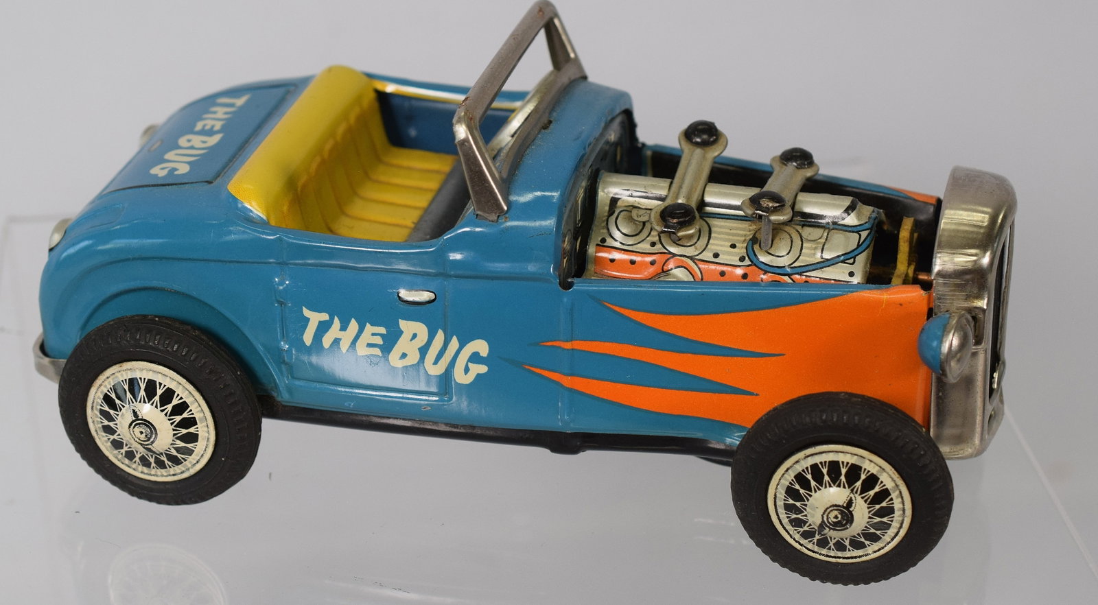 JAPAN TIN FRICTION THE BUG HOT ROD CAR: All original with great colors. Has moving pistons and friction works. 8 inches x 3 3/4 x 3 1/2 tall and 1 pound. Good condition.