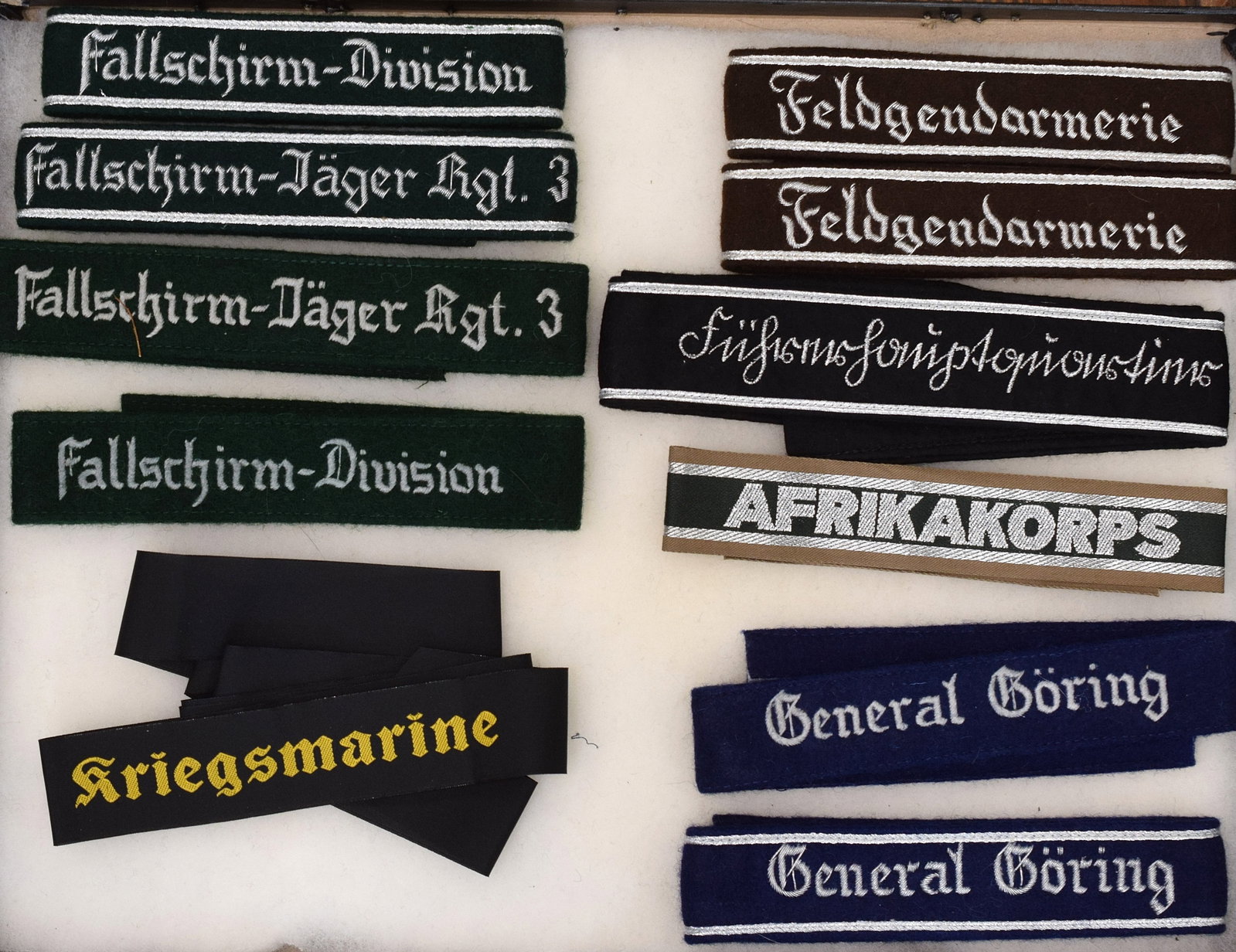 RIKER CASE GERMAN CUFF TITLE VARIANTS: Consists of 11 pieces. Estate collection of William Bureau of WWII Third Reich Militaria. Consists of Two badges. Collection are antique, new, vintage and reproductions pieces. Shipping 12 x 16 x 2 an