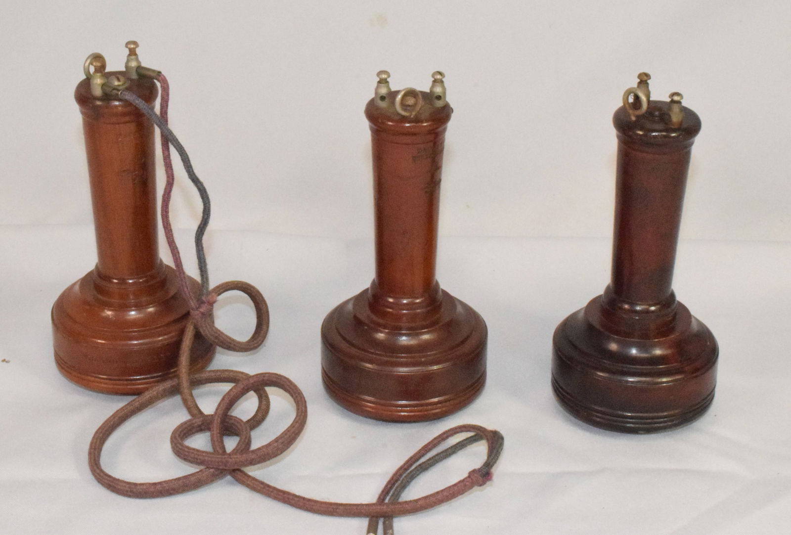 (3) RARE BELL WOODEN HAND BUTTER STAMP RECEIVERS: Early wooden hand telephone butterstamp receivers. 1) marked Bell Telephonr Company 109 Court St Boston. Light mark. Stamp number that we can not make out. 6 3/8 inches long. Good condition. 2)Marked