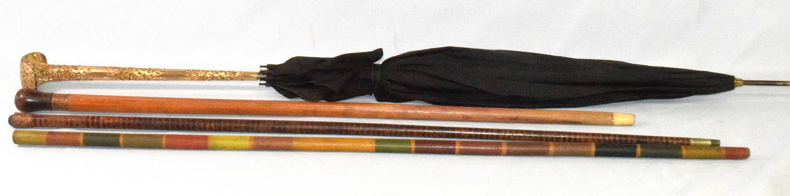 VICTORIAN WALKING STICKS AND PARASOL GROUPING: 19th Walking stick and parasol grouping. 1) Walking stick with a seeded silver U.S. coin on top, copper band and bone tip . Good condition. Measures approx.31.5 inches long. 2) Walking stick with copp