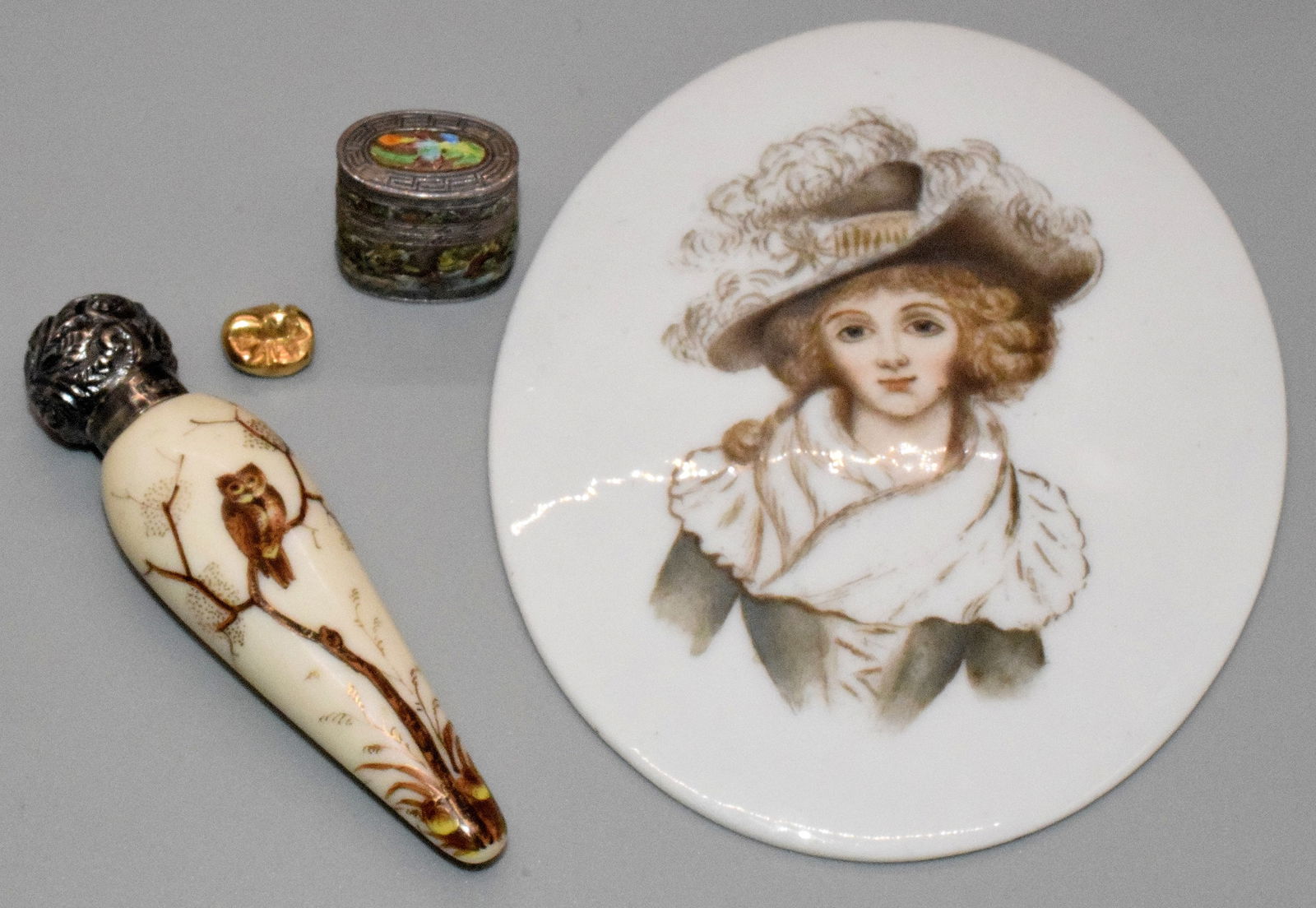 ASSEMBLED ITEMS. SCENT BOTTLE, OVAL PORTRAIT & ETC: Consists of a mixed grouping 1) English sterling repoussee top scent bottle with hand painted porcelian bottle. 3 3/8 inches long. painted owl. 2) Miniture Chinese enamel silver pill box withgold dent