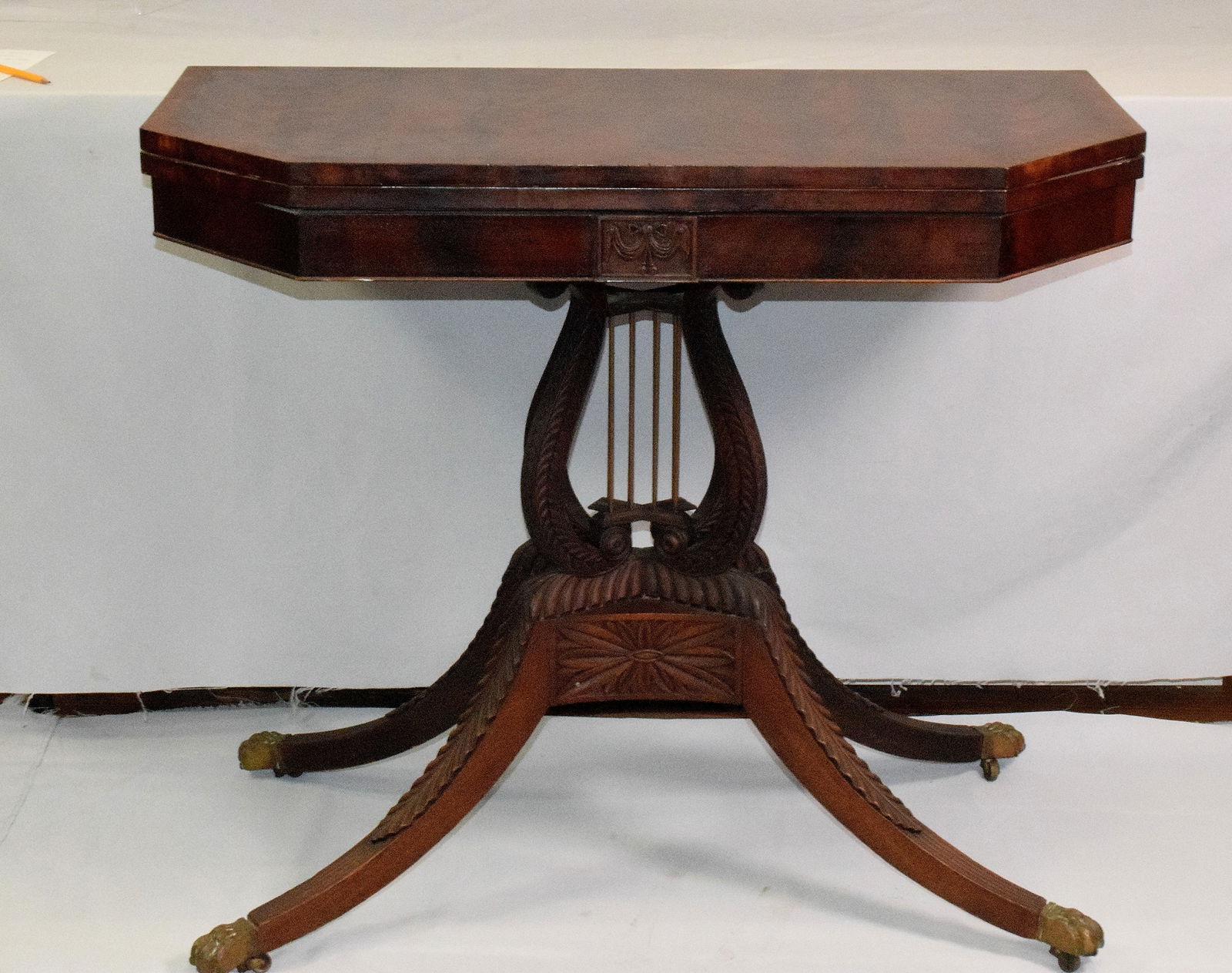 CLASSICAL MAHOGANY LYRE CARD OR GAME TABLE: New York or Philadelphia classical card table. Great carving on legs and lyre base. Carved drape and swags plaque front. Looks like the style of the workshop of Duncan Phyfe. Attib. to DuncanPhyfe. Es