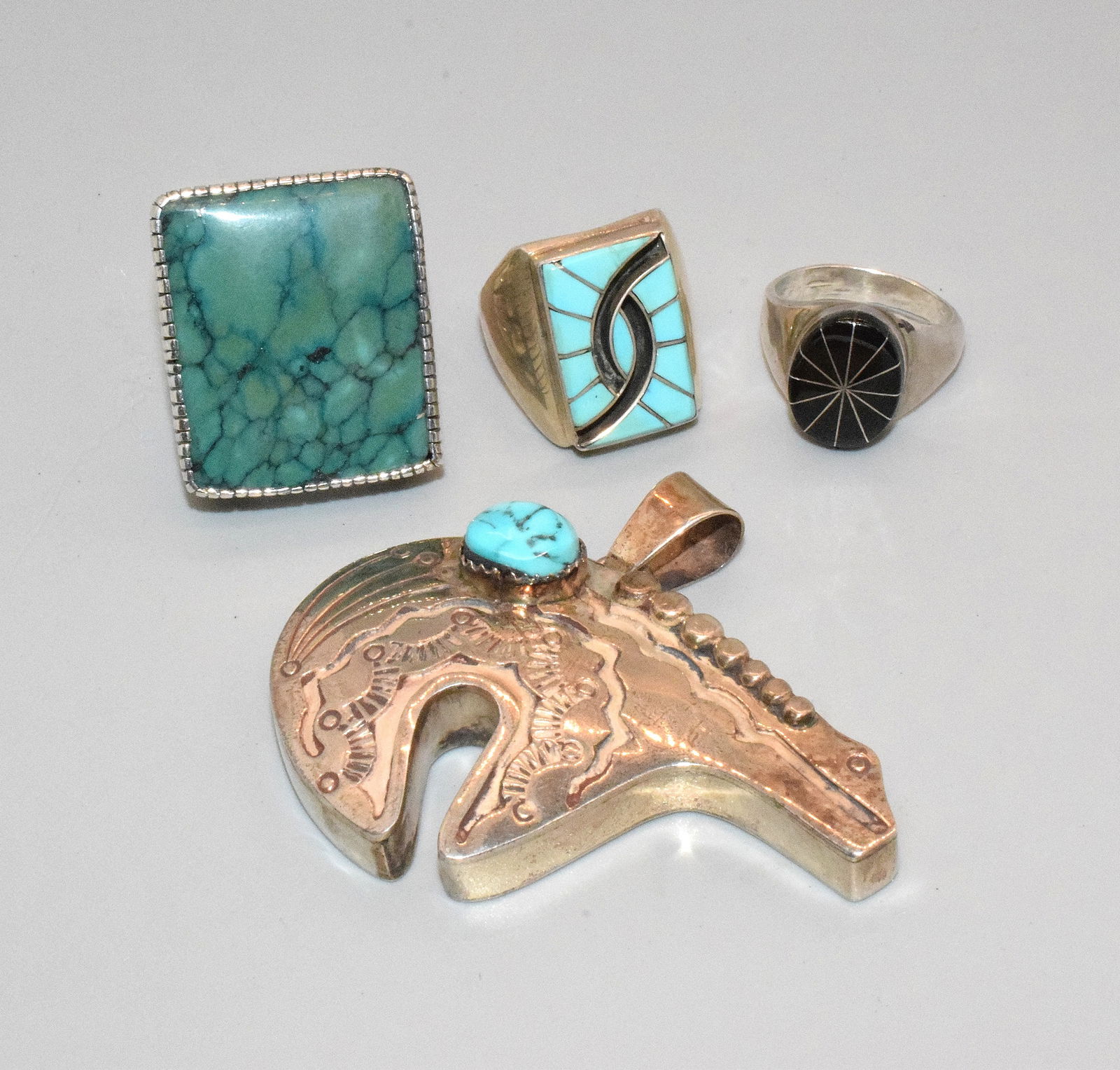 ASSEMBLED NATIVE AMERICAN STERLING SILVER JEWELRY: Consists of 1) Signed SV turquoise and sterling bear pendant. 2 1/2 inches long. 2) EB sterling & turquoise ring. Ring size 10. Good condition. 3) Large Robert Lee Morris signed RLM turquoise and ster