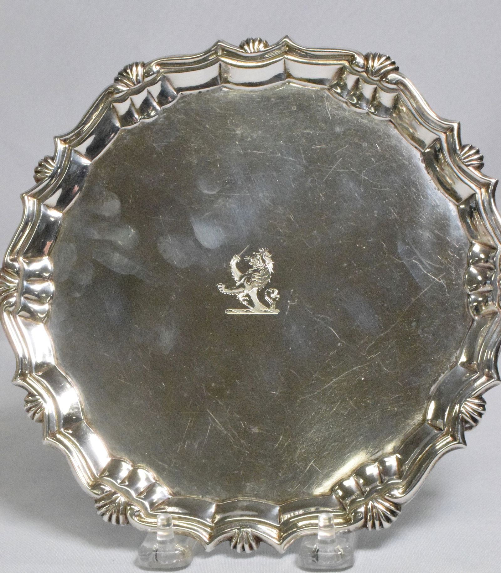 EARLY ENGLISH GEORGIAN SILVER FOOTED SALVER: Early English Georgie II silver footed salver. 7 1/2 inches in diameter. Hallmarked Leopard's Head crowned, "P", Lion Passant facing left mark, "RA". Believe Robert Abercrombie Ca 1740. Approx. 10.34