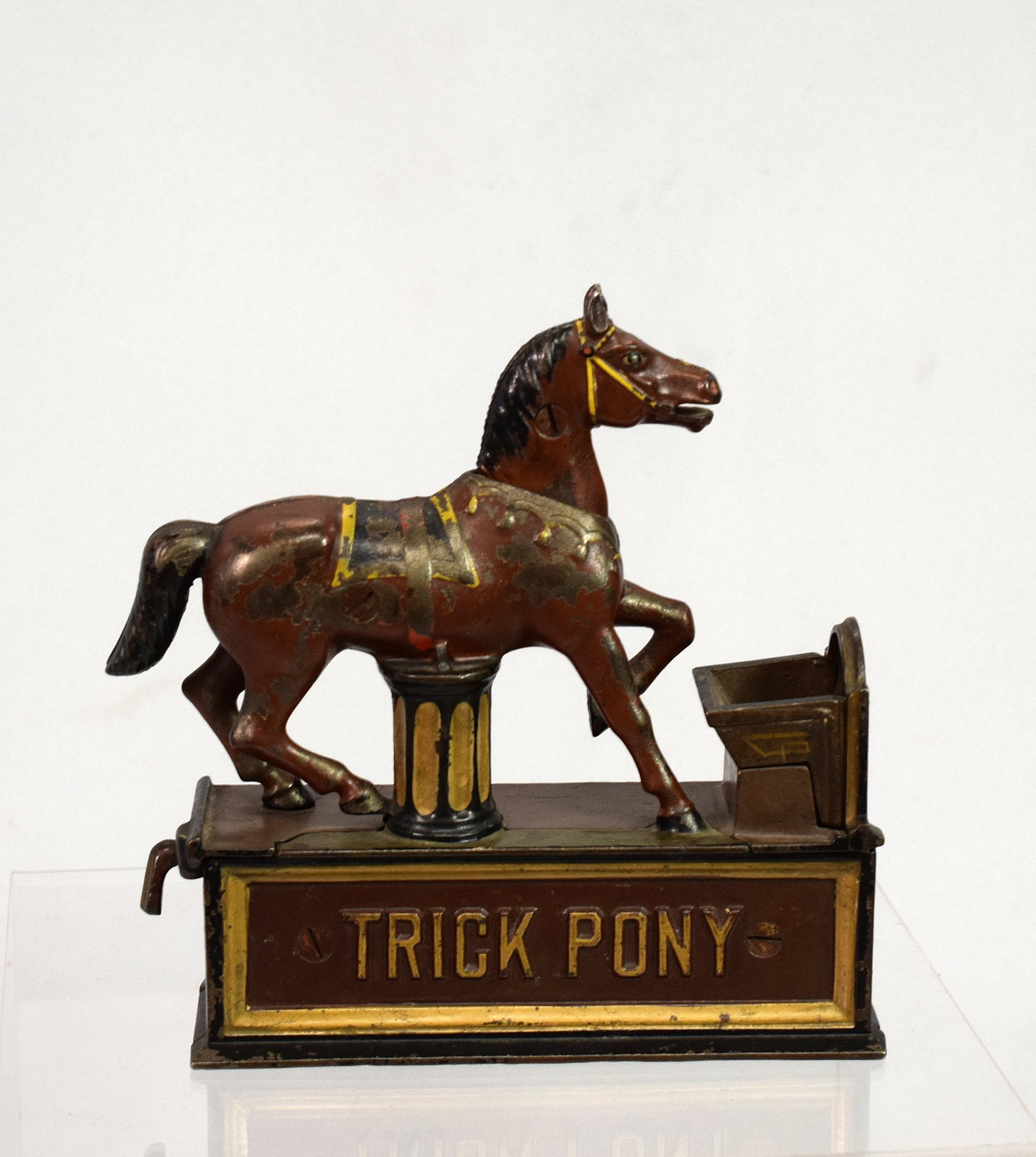 TRICK PONY CAST IRON MECHANICAL BANK: Anitigue original Shepard hardware cast iron mechanical bank. Circa 1885. Original paint. Blacklighted seems all original. Working. 7 3/4 inches tall. x 8 inches long x 2 1/2 inches wide.Good conditio
