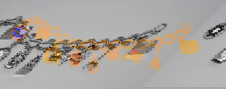 14K,18K, & 10K GOLD CHARM BRACELET: Linked design bracelet. 6 1/2 inches long. 2 charms are 18k. 6 charms are 14k. 1 charm is 10k. Weights break down this way. 18k = 6.1 DWT. 14k = 18.3 DWT and 10k =.7 DWT. Whites auctions will not take
