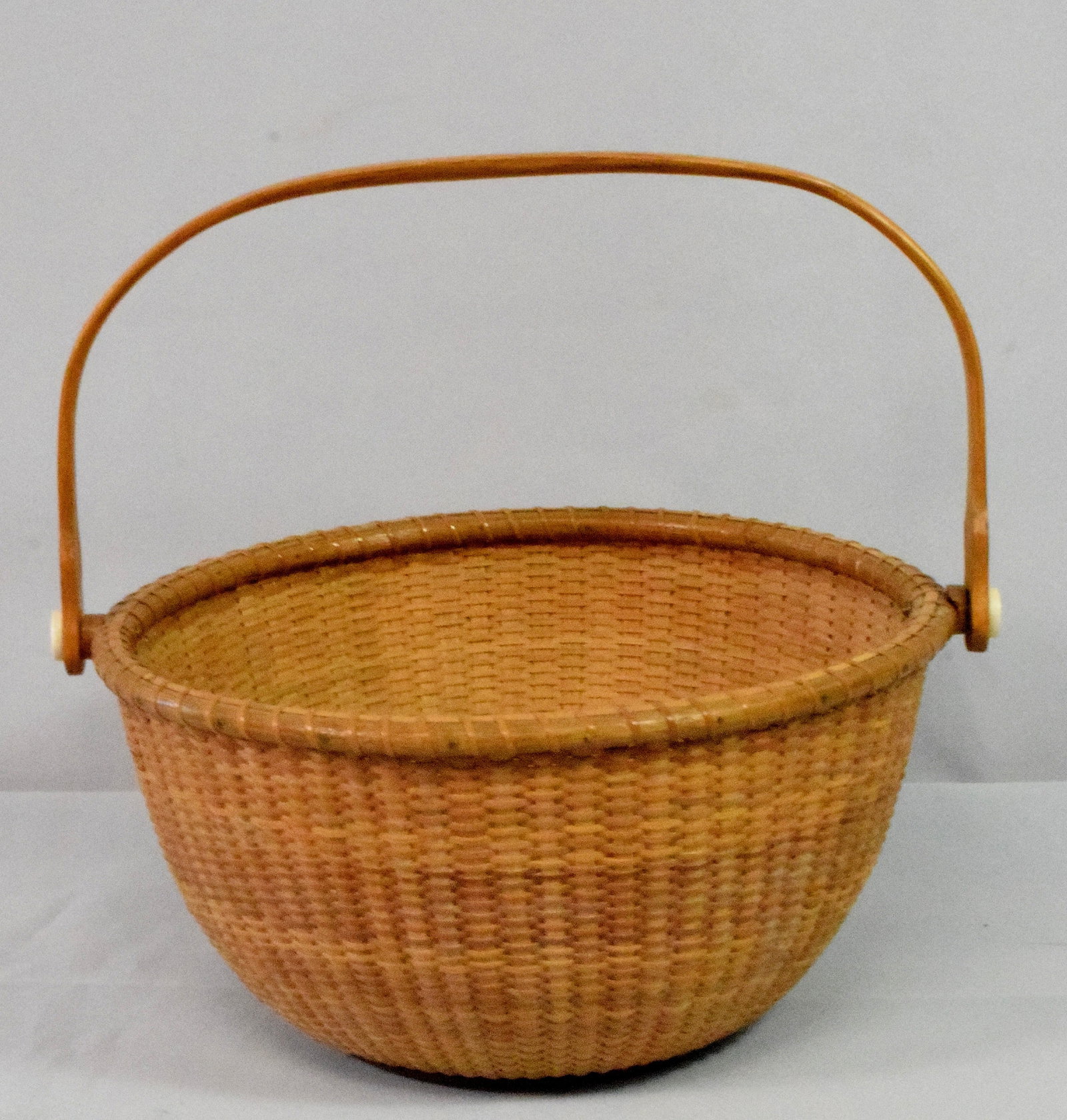 MODERN SWING HANDLE NANTUCKET BASKET: Signed JEM 2007. 10 inches diameter x 5 1/2 inches tall. Good condition.