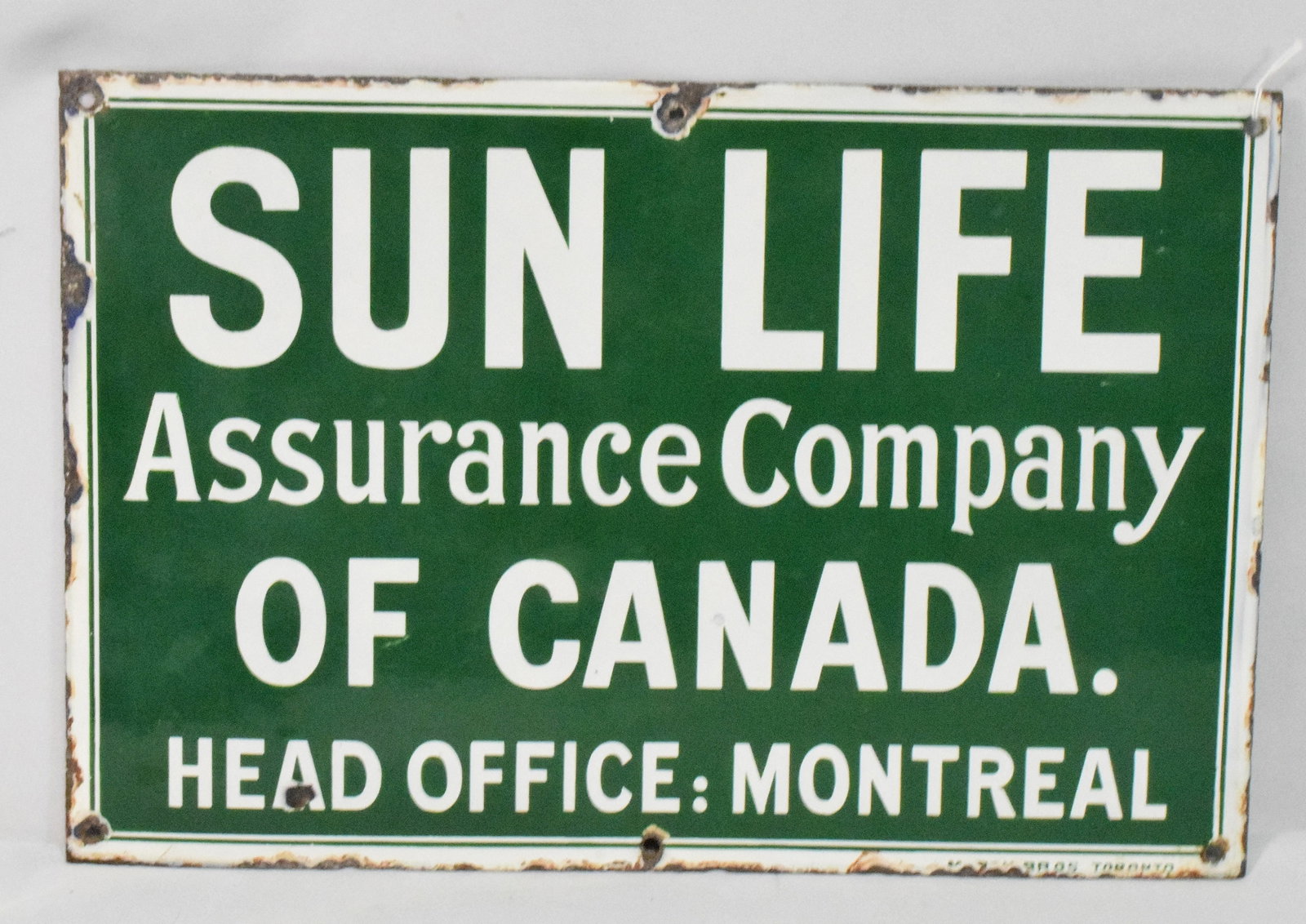 SUN LIFE OF CANADA PORCELAIN SIGN: Canadian. 1930s. Porcelain. 12 x 18". Minor surface and edge wear. Single sided. Some edge wear. As is. Shipping weight 2 pounds.