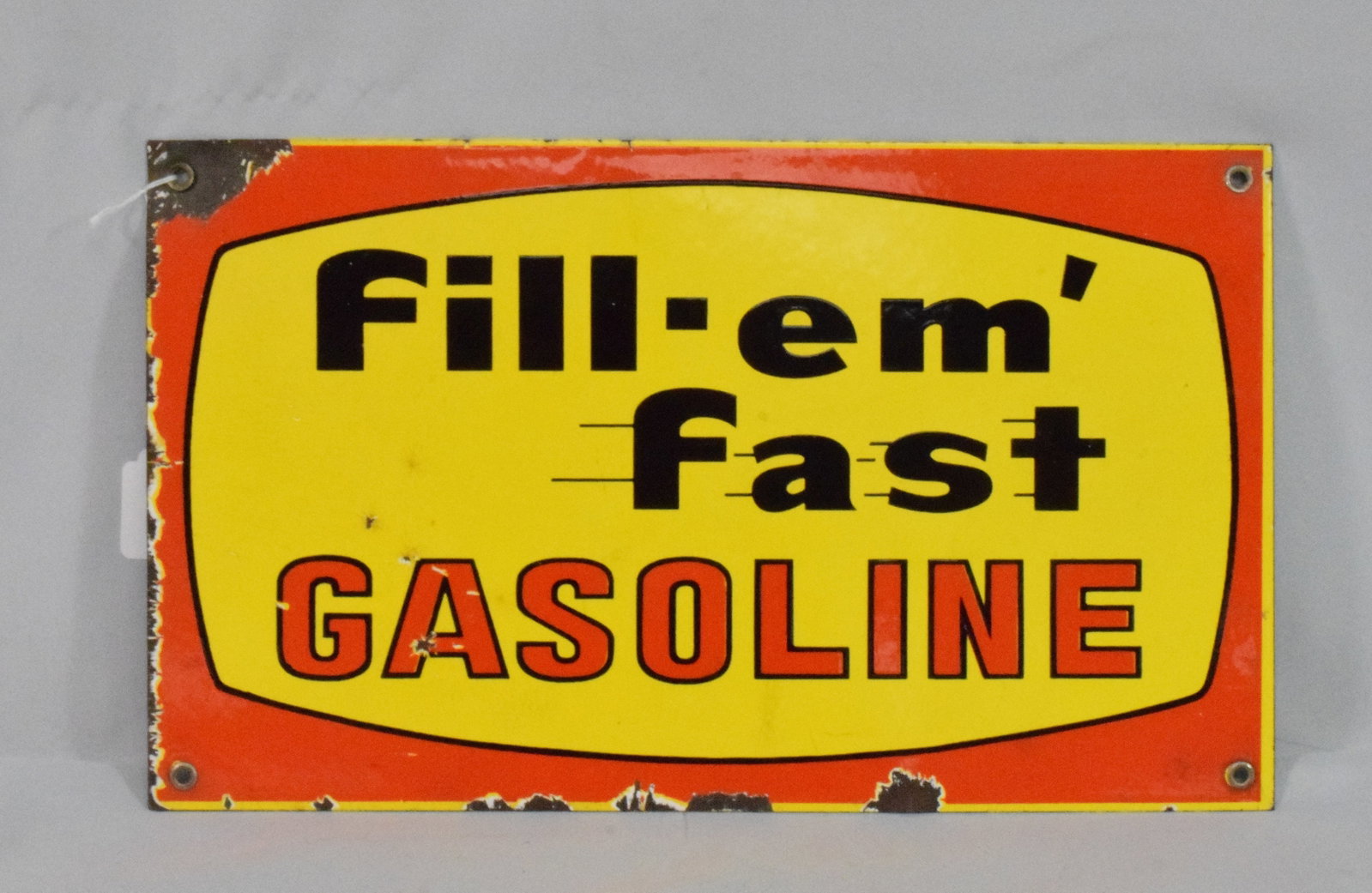 FILL EM FAST GASOLINE SIGN: 16 inches x 9 1/2 inches. Single sided. Wear and chips on edges. As is. Shipping weight 2 pounds.
