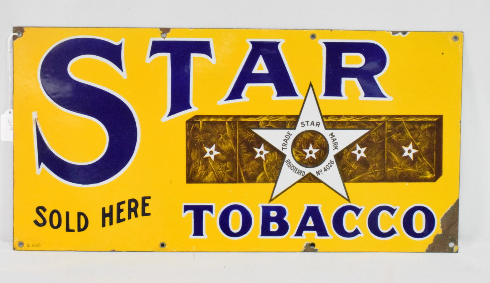 STAR TOBACCO PORCELAIN SIGN: Single sided. Marked and dated GI35. Ca 1935. 24 inches x 12 inches. Some wear.