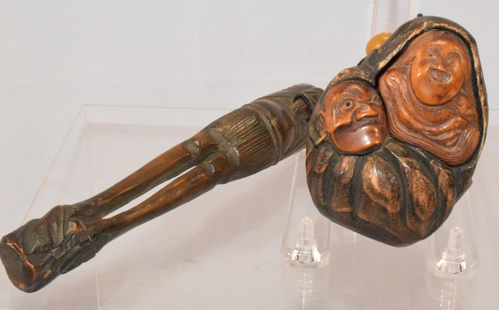 JAPANESE CARVED WOOD TOBAKO-IRE & PIPE HOLDER: Japanese carved figural Tobako-ire and figural Kiseru-Zutsu. Tobacco vase with carved female bust and Samurai face. Measures 3 1/4 inches x 1 1/2 inches. Figural pipe case 8 inches. Good condition.
