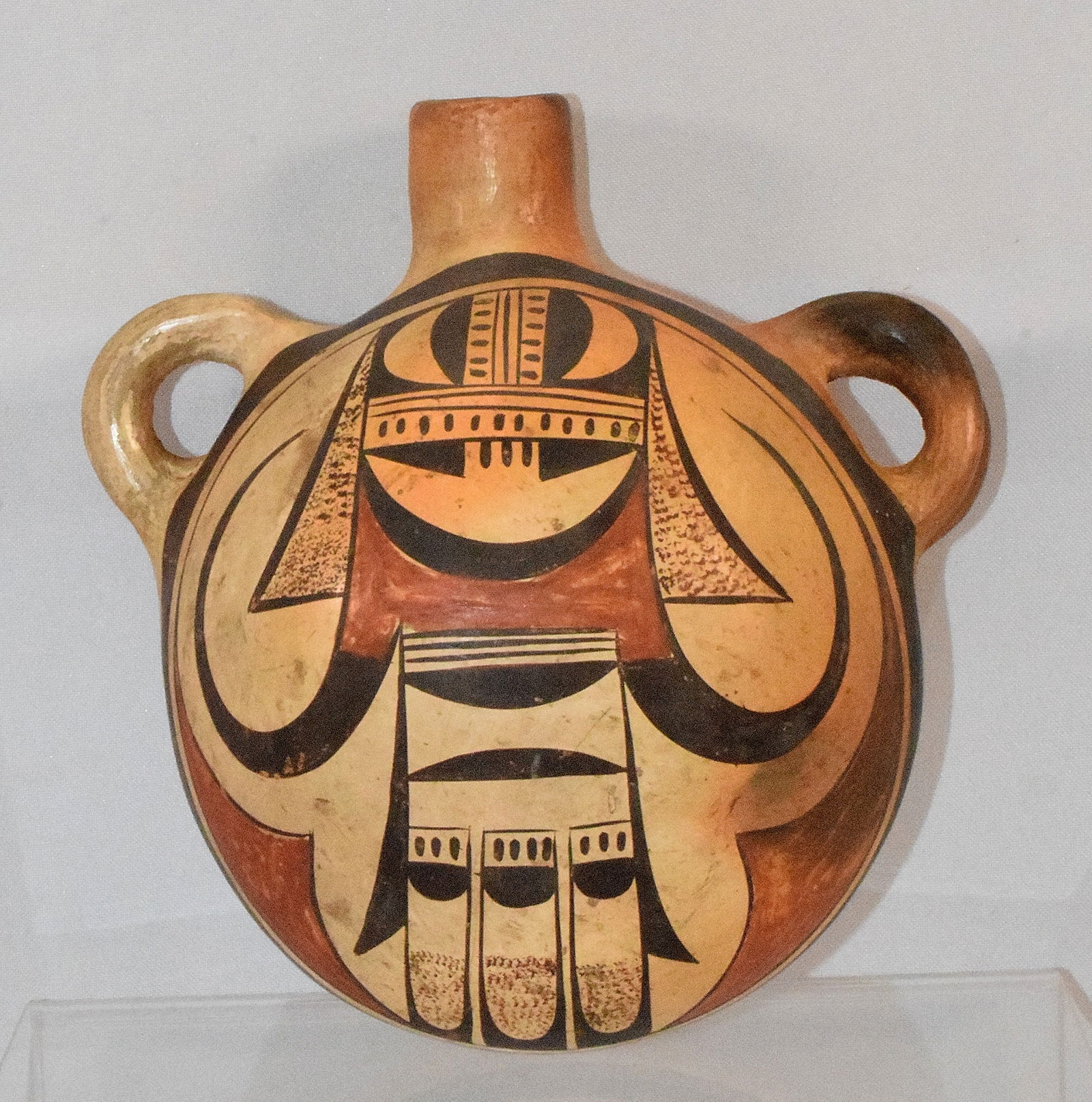 ACOMA POLYCHROME TWO COLOR POTTERY CANTEEN: Antique Acoma Pueblo Canteen. Decorated one side.6 1/4 inches tall. x 6 inches handle to handle end. Approx. 6 inches tall x 6 inches wide x 4 3/4 inches deep. Good condition. Nice patina. Shipping we