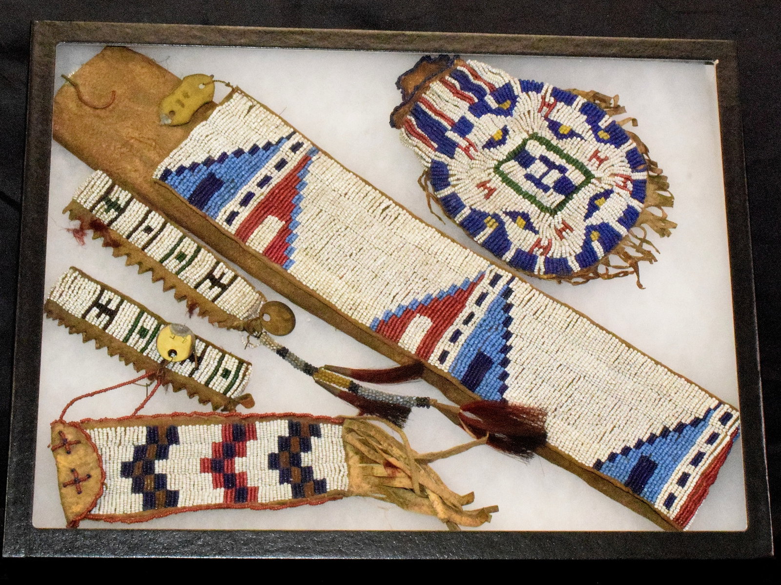(4) ASSEMBLED NATIVE AMERICAN BEADED PIECES: Consists of 4 Plains Indian pieces in this lot. 1) Ca 1905. Souix Native American fully beaded belt, worn on festival occasions. Fully covered fine bead work on hide backing. Geometric pattern in red,
